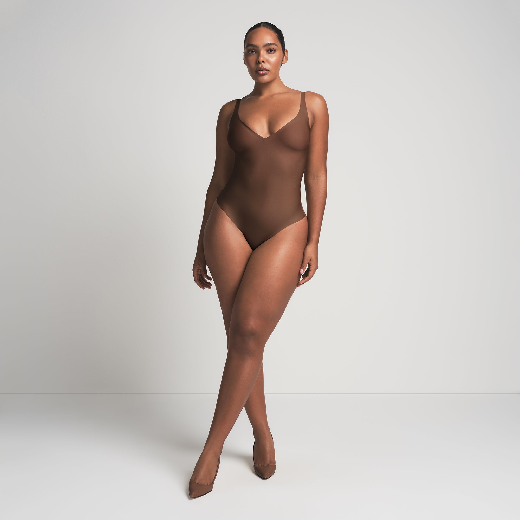 SKIMS BODY UNLINED PLUNGE THONG BODYSUIT | JASPER ON A MODEL FRONT VIEW @