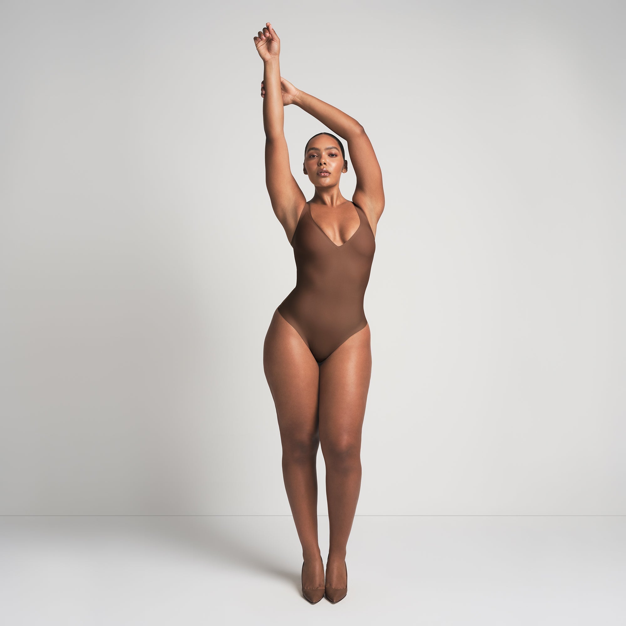 SKIMS BODY UNLINED PLUNGE THONG BODYSUIT | JASPER ON A MODEL FRONT VIEW @