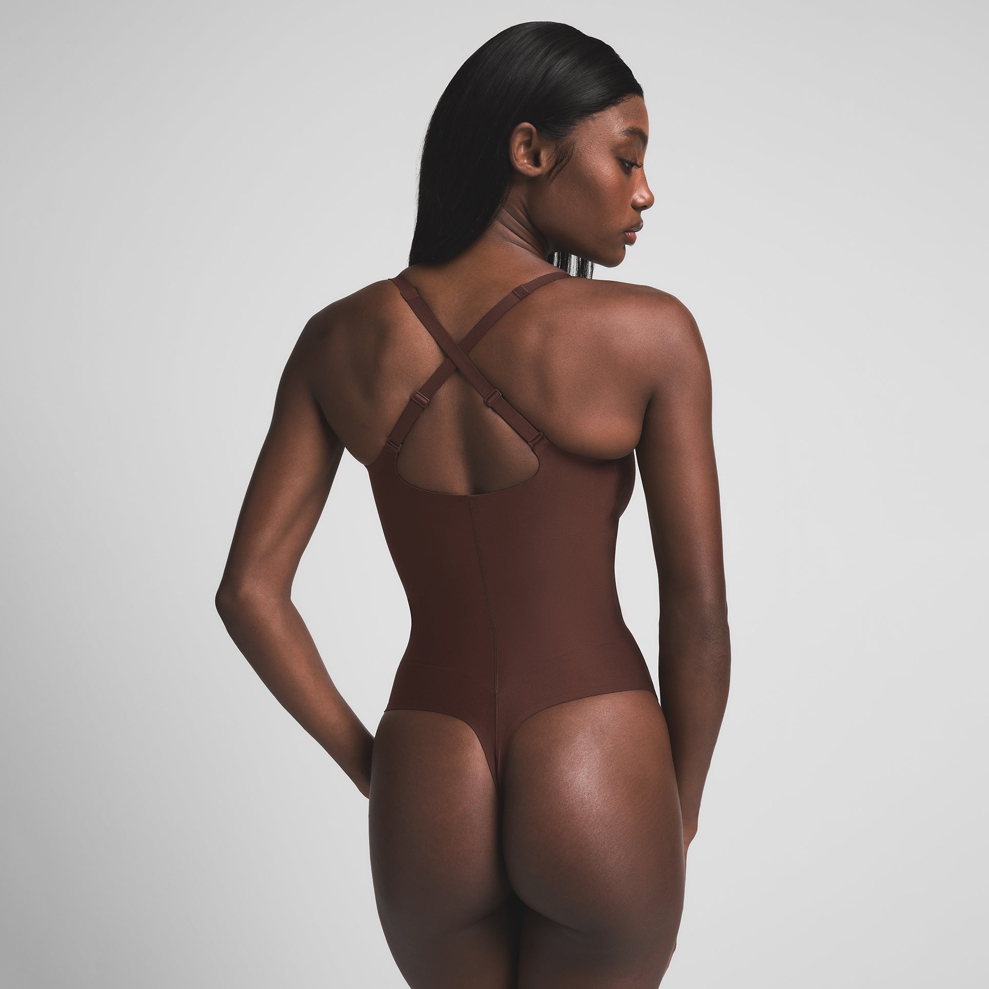 SKIMS BODY CORE SCULPT PLUNGE THONG BODYSUIT | COCOA ON A MODEL BACK VIEW