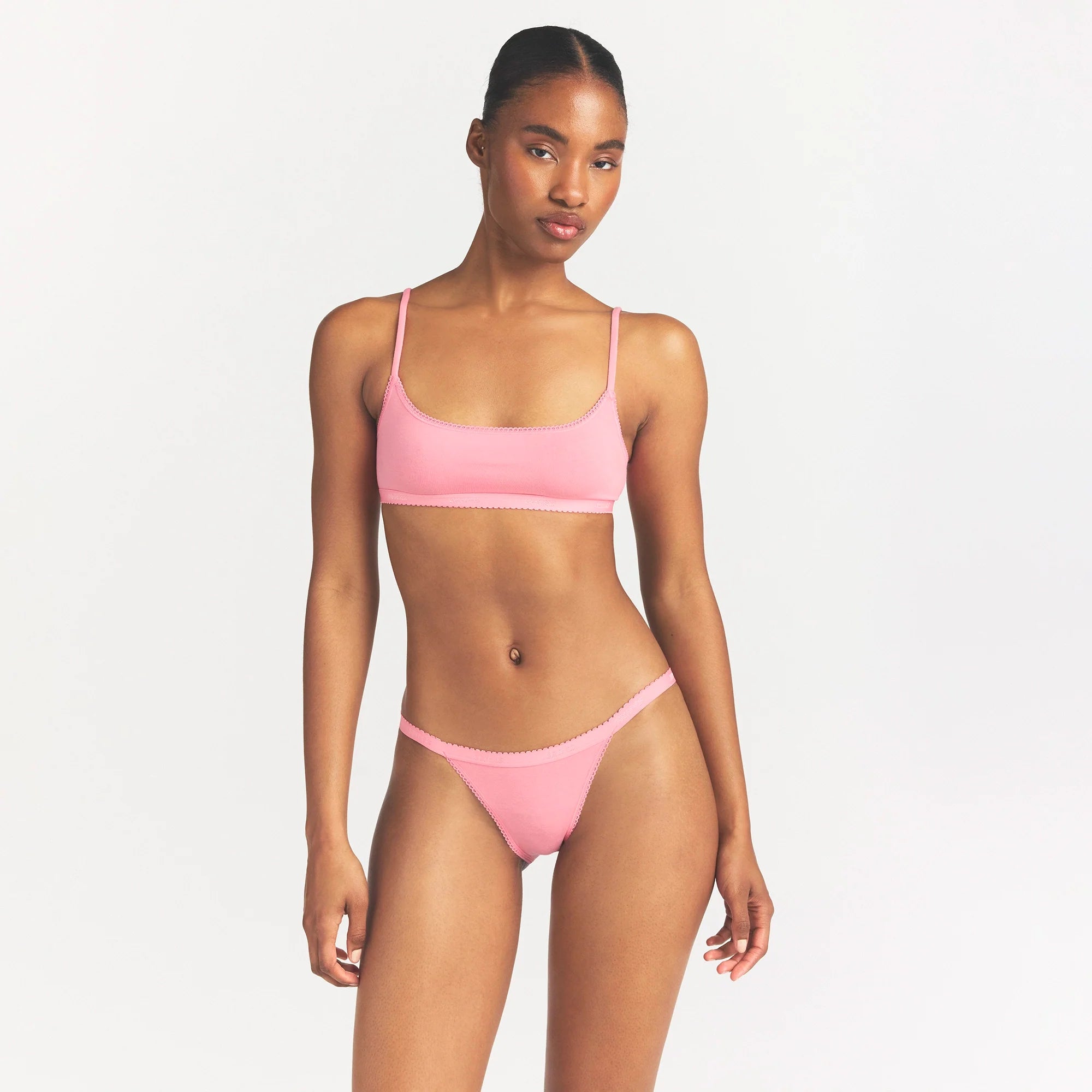 LIGHTWEIGHT COTTON LOGO PICOT STRING BIKINI | MELON TONAL ON A MODEL SIDE VIEW @ | FOCUS: 0.0, 1.0, 0.9