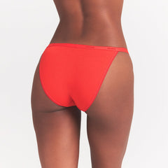 LIGHTWEIGHT COTTON LOGO PICOT STRING BIKINI | RUBY TONAL ON A MODEL BACK VIEW @ | FOCUS: 0.0, 1.0, 0.9