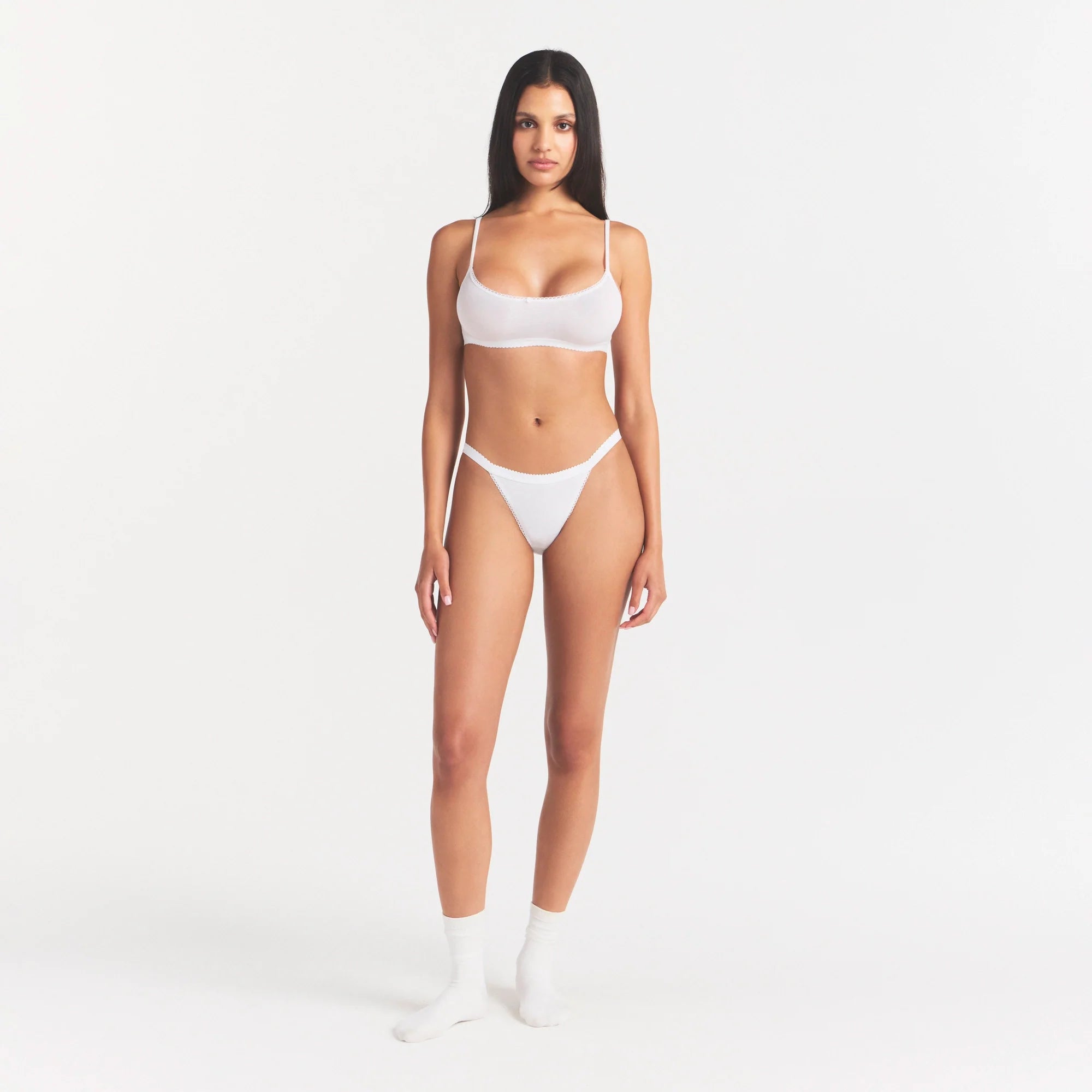 LIGHTWEIGHT COTTON LOGO PICOT STRING BIKINI | SNOW ON A MODEL FRONT VIEW | FOCUS: 0.0, 1.0, 0.9