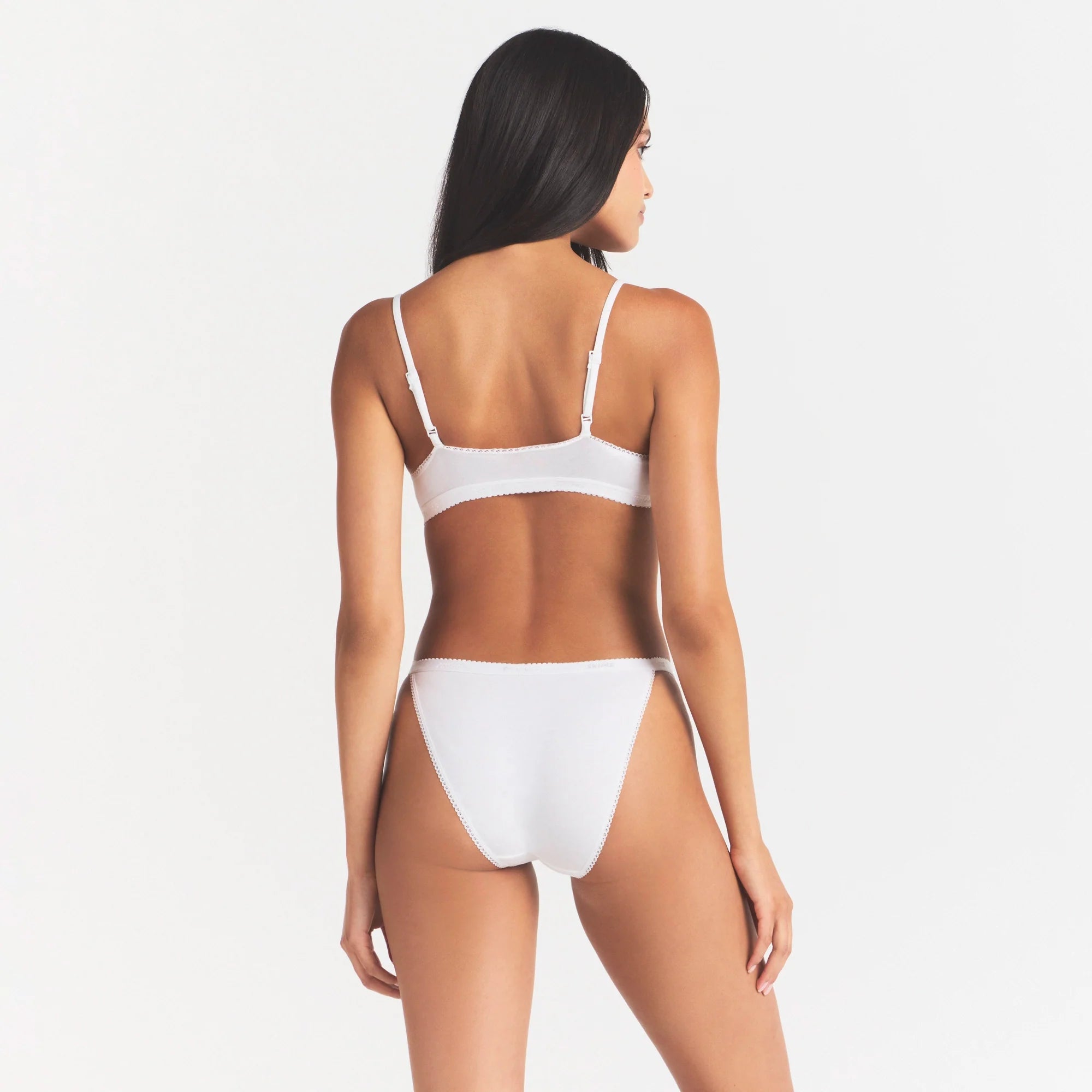 LIGHTWEIGHT COTTON LOGO PICOT STRING BIKINI | SNOW ON A MODEL SIDE VIEW | FOCUS: 0.0, 1.0, 0.9