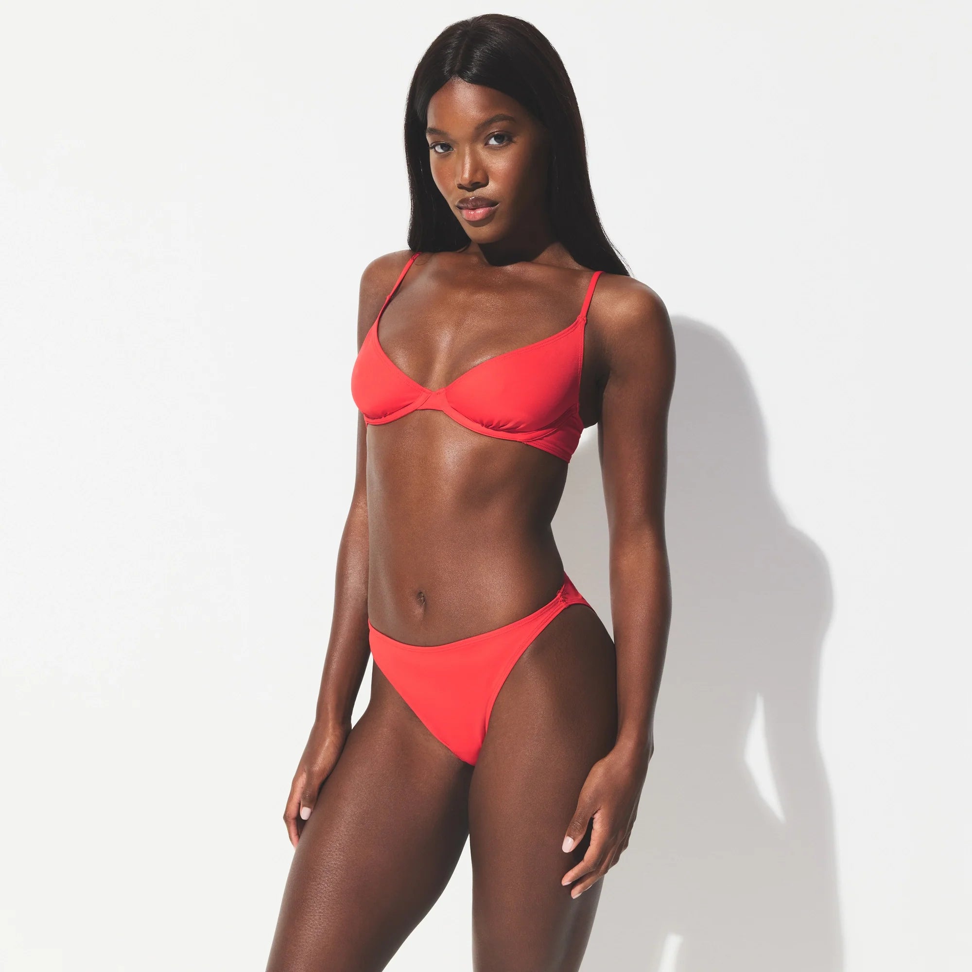 ICONIC SWIM HIGH LEG BIKINI BOTTOM | CARMINE ON A MODEL SIDE VIEW @ | FOCUS: 0.0, 1.0, 0.9 
