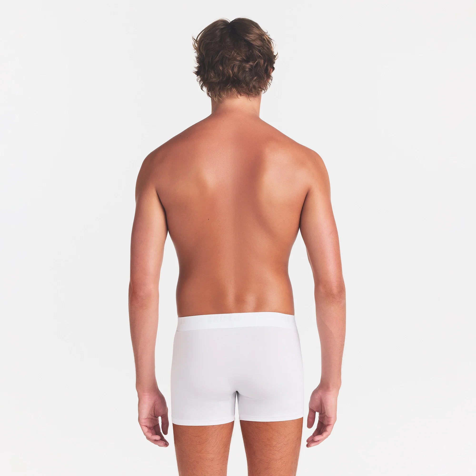 SKIMS STRETCH MENS 5" BOXER BRIEF | CHALK ON A MODEL BACK VIEW