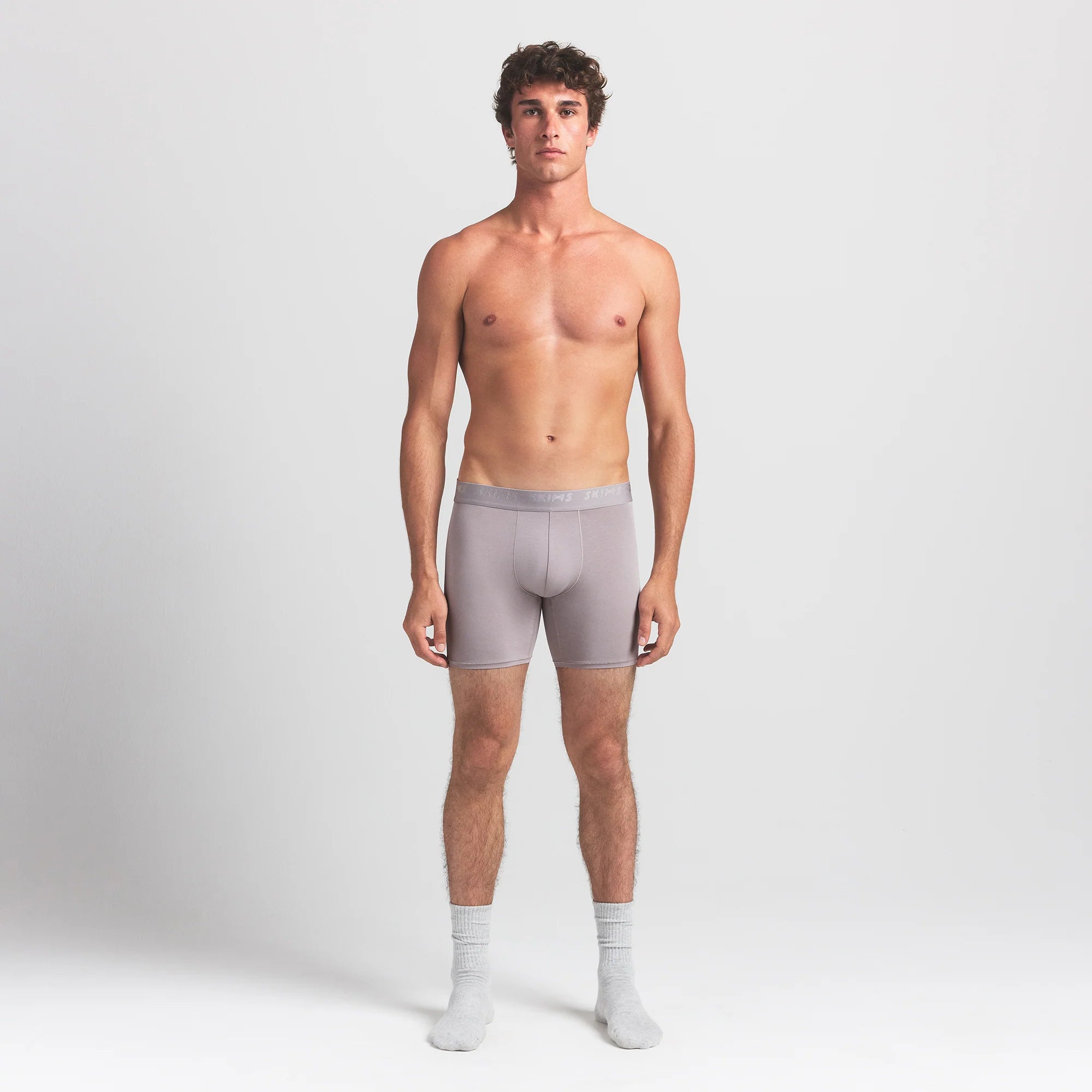 SKIMS STRETCH MENS 5" BOXER BRIEF | OYSTER ON A MODEL FRONT VIEW @ | FOCUS: 0.0, 1.0, 0.9