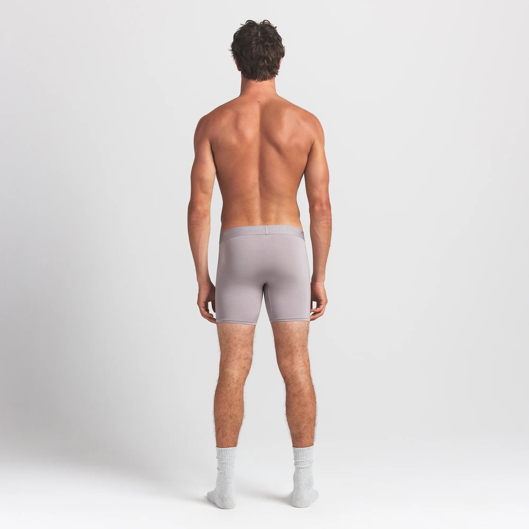 SKIMS STRETCH MENS 5" BOXER BRIEF | OYSTER ON A MODEL BACK VIEW @ | FOCUS: 0.0, 1.0, 0.9
