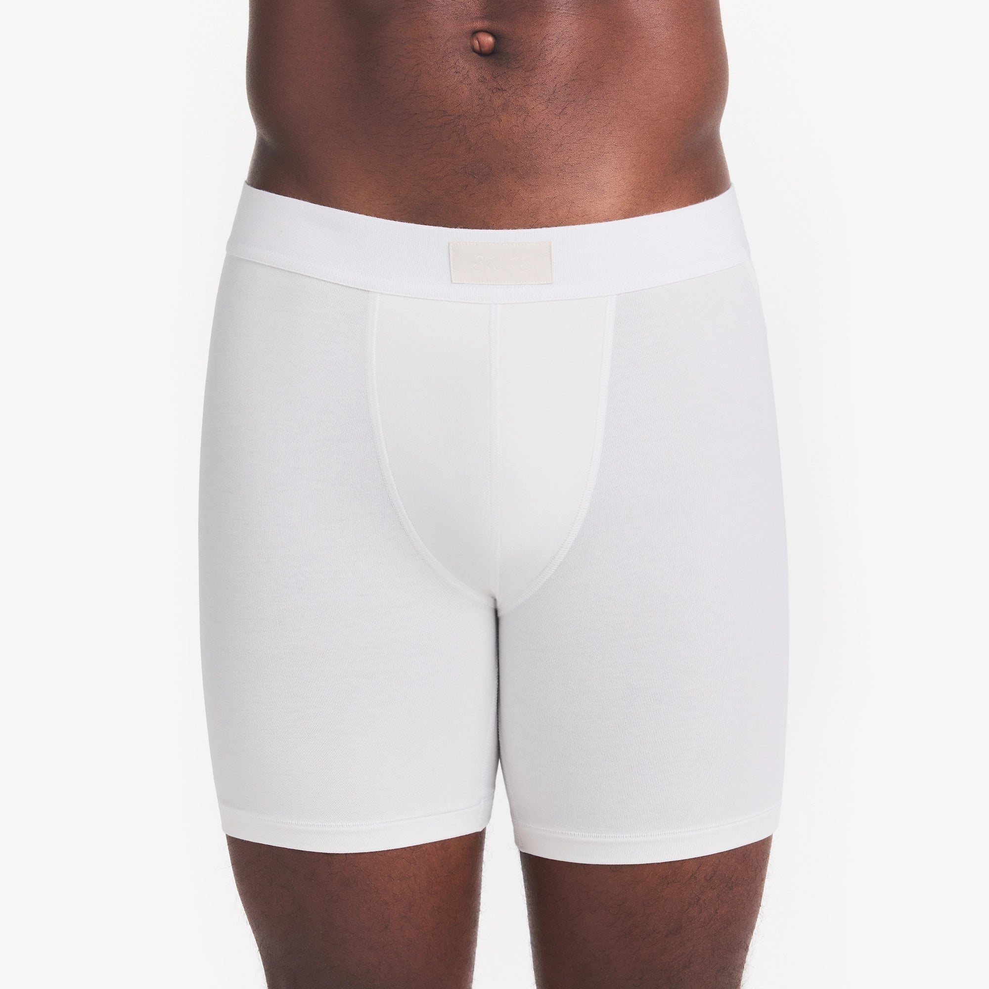 SKIMS COTTON MENS 5" BOXER BRIEF | CHALK ON A MODEL FRONT VIEW