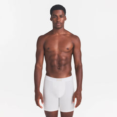 SKIMS COTTON MENS 5" BOXER BRIEF | CHALK ON A MODEL FRONT VIEW