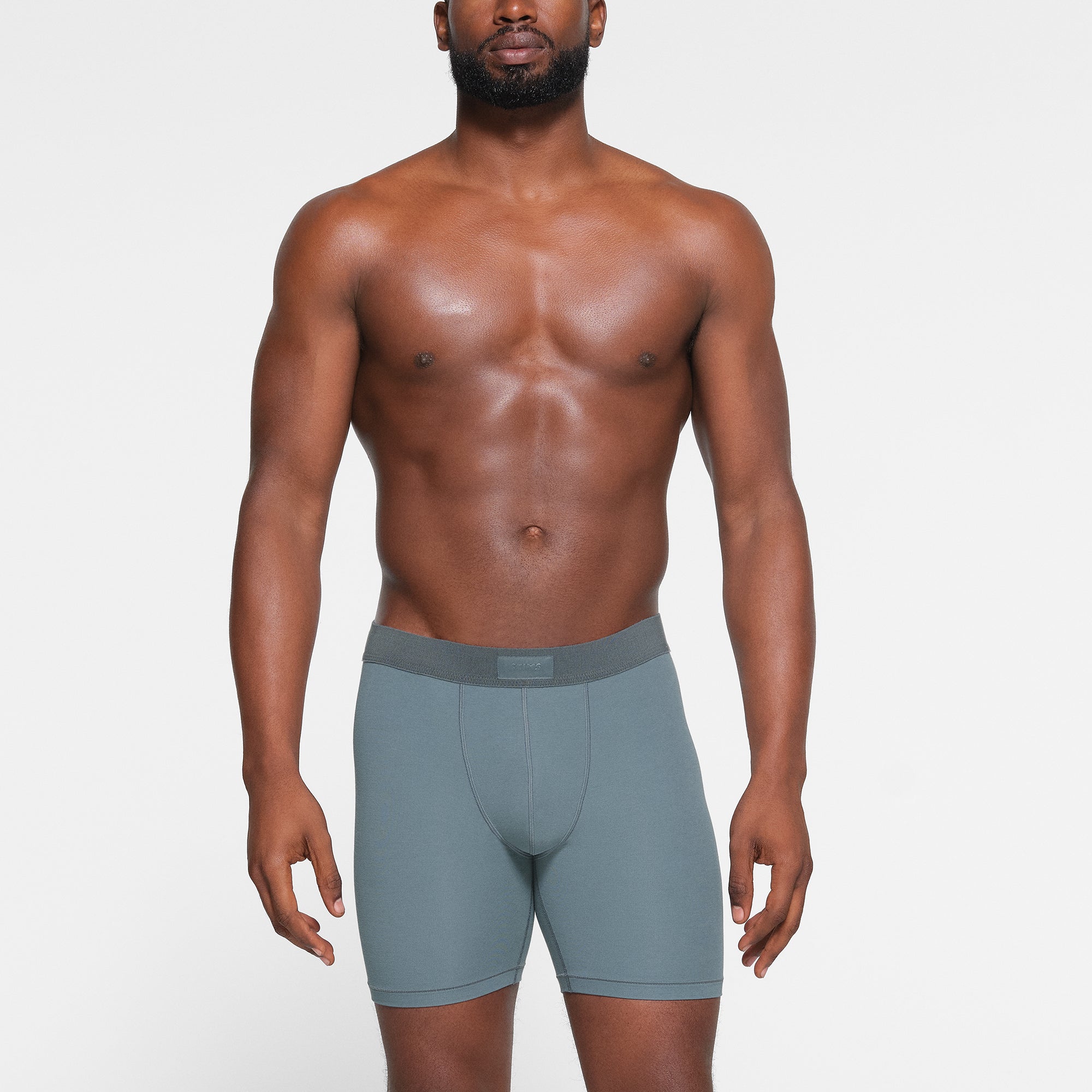 SKIMS COTTON MENS 5" BOXER BRIEF 3-PACK WORN BY A MODEL IN FRONT VIEW