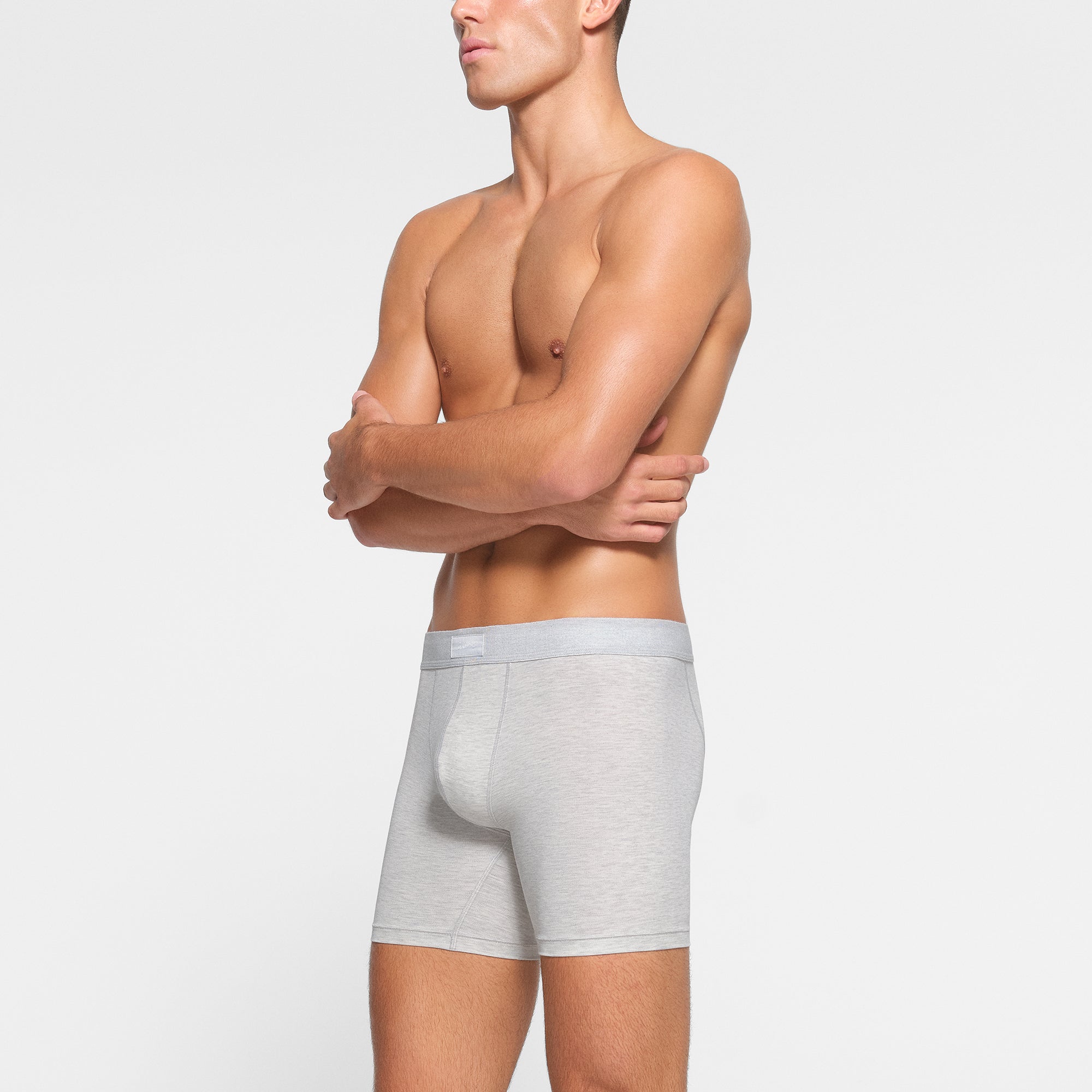 SKIMS COTTON MENS 5" BOXER BRIEF 3-PACK WORN BY A MODEL IN SIDE VIEW