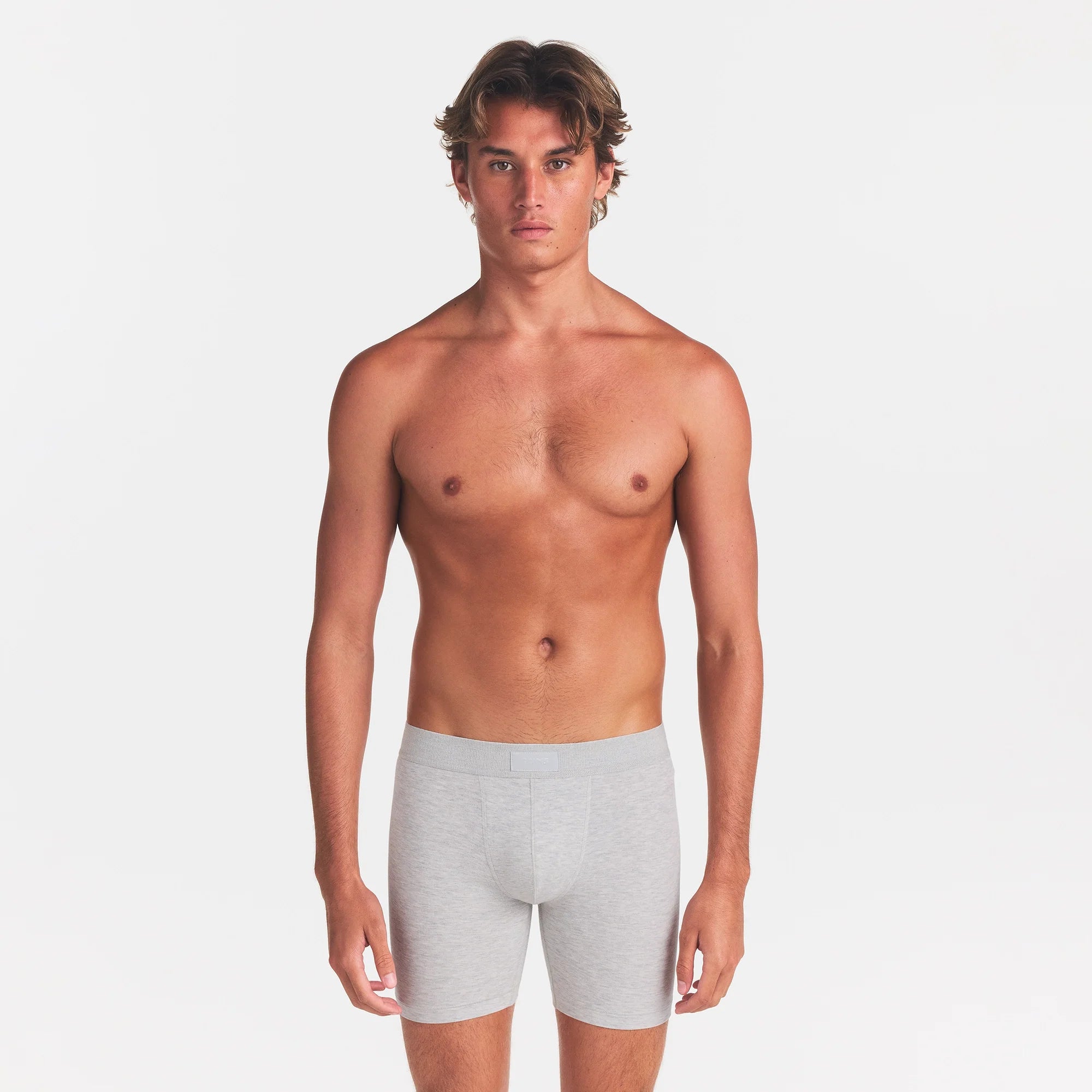 SKIMS COTTON MENS 5" BOXER BRIEF | LIGHT HEATHER GREY ON A MODEL FRONT VIEW