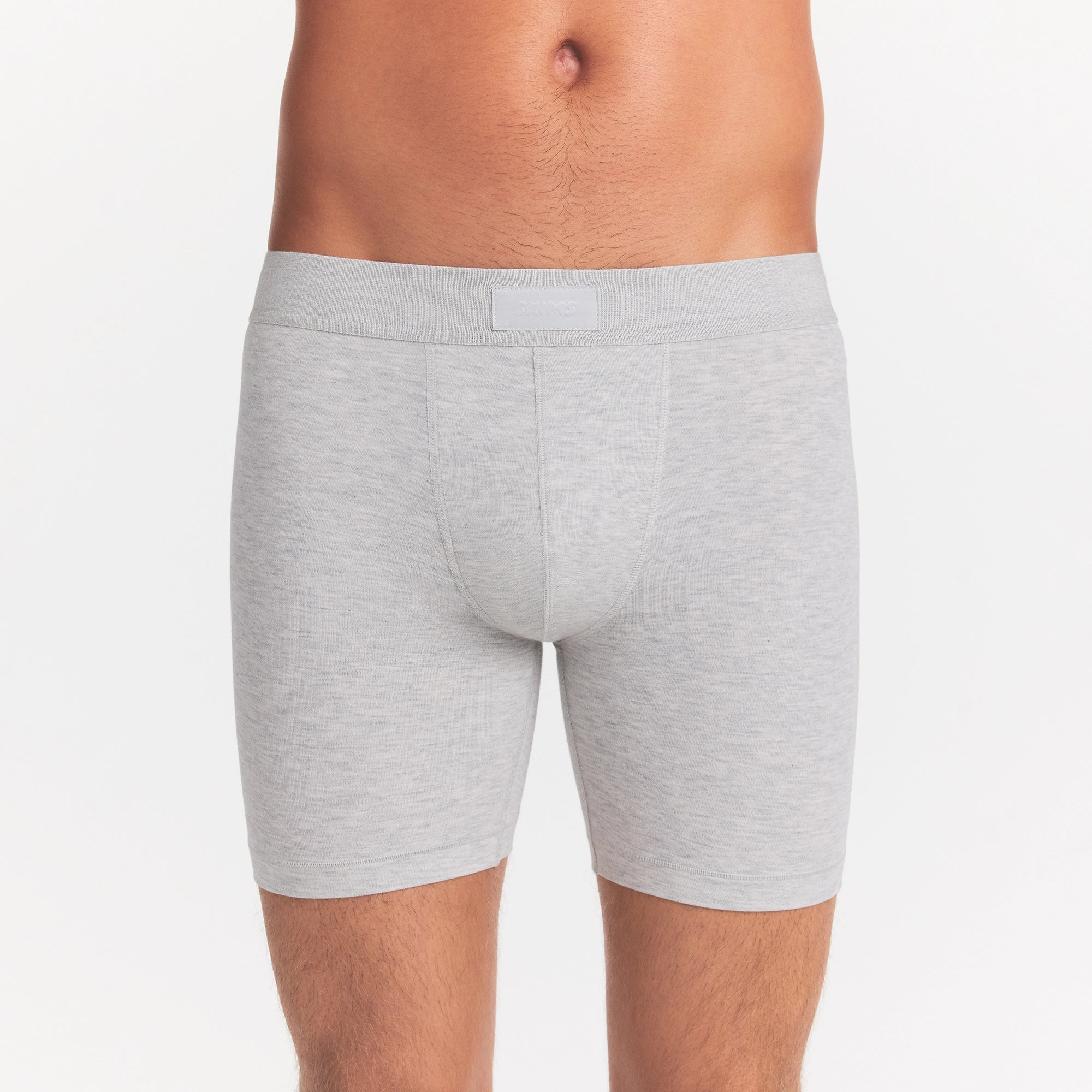 SKIMS COTTON MENS 5" BOXER BRIEF | LIGHT HEATHER GREY ON A MODEL FRONT VIEW