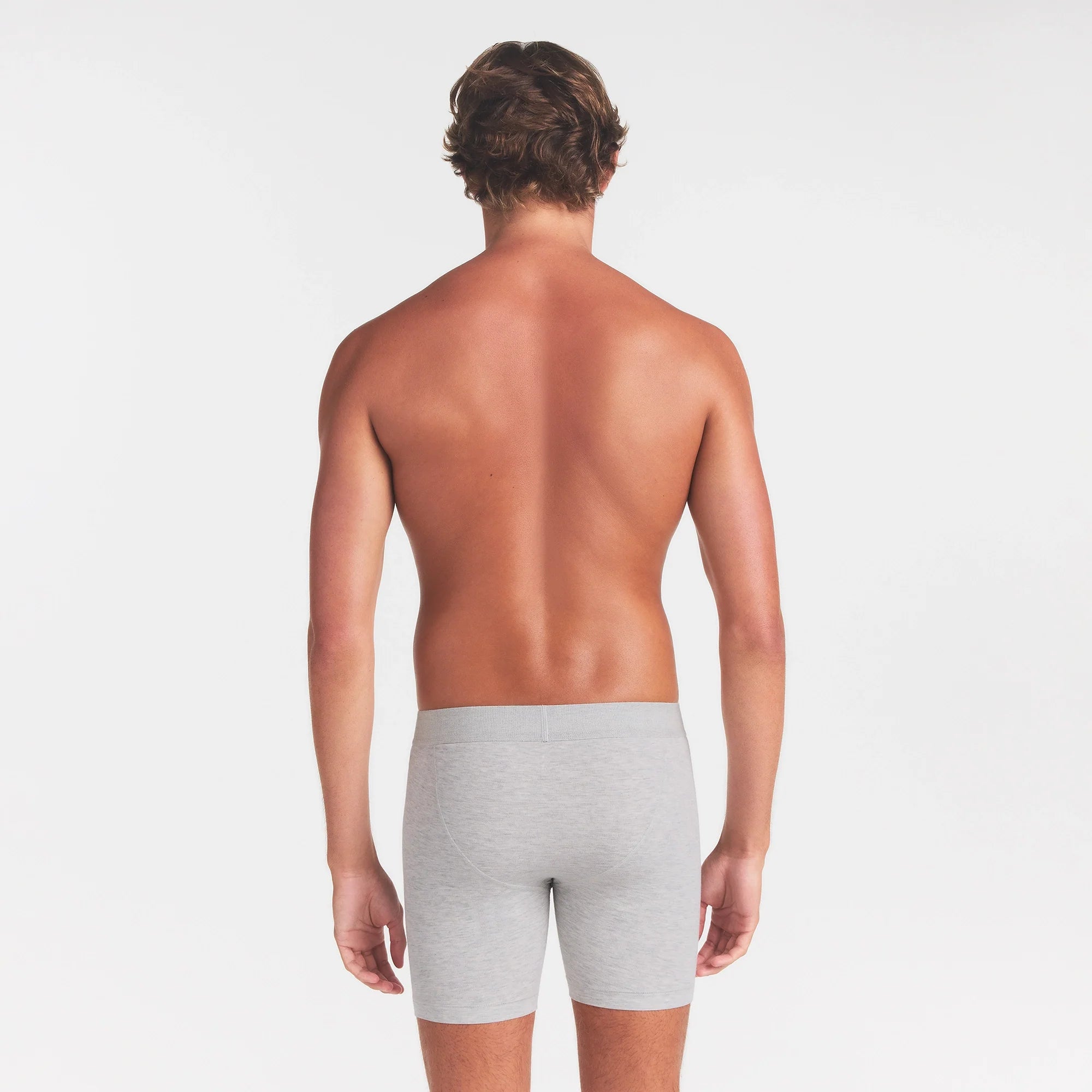 SKIMS COTTON MENS 5" BOXER BRIEF | LIGHT HEATHER GREY ON A MODEL BACK VIEW