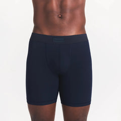 SKIMS COTTON MENS 5" BOXER BRIEF | NAVY ON A MODEL FRONT VIEW