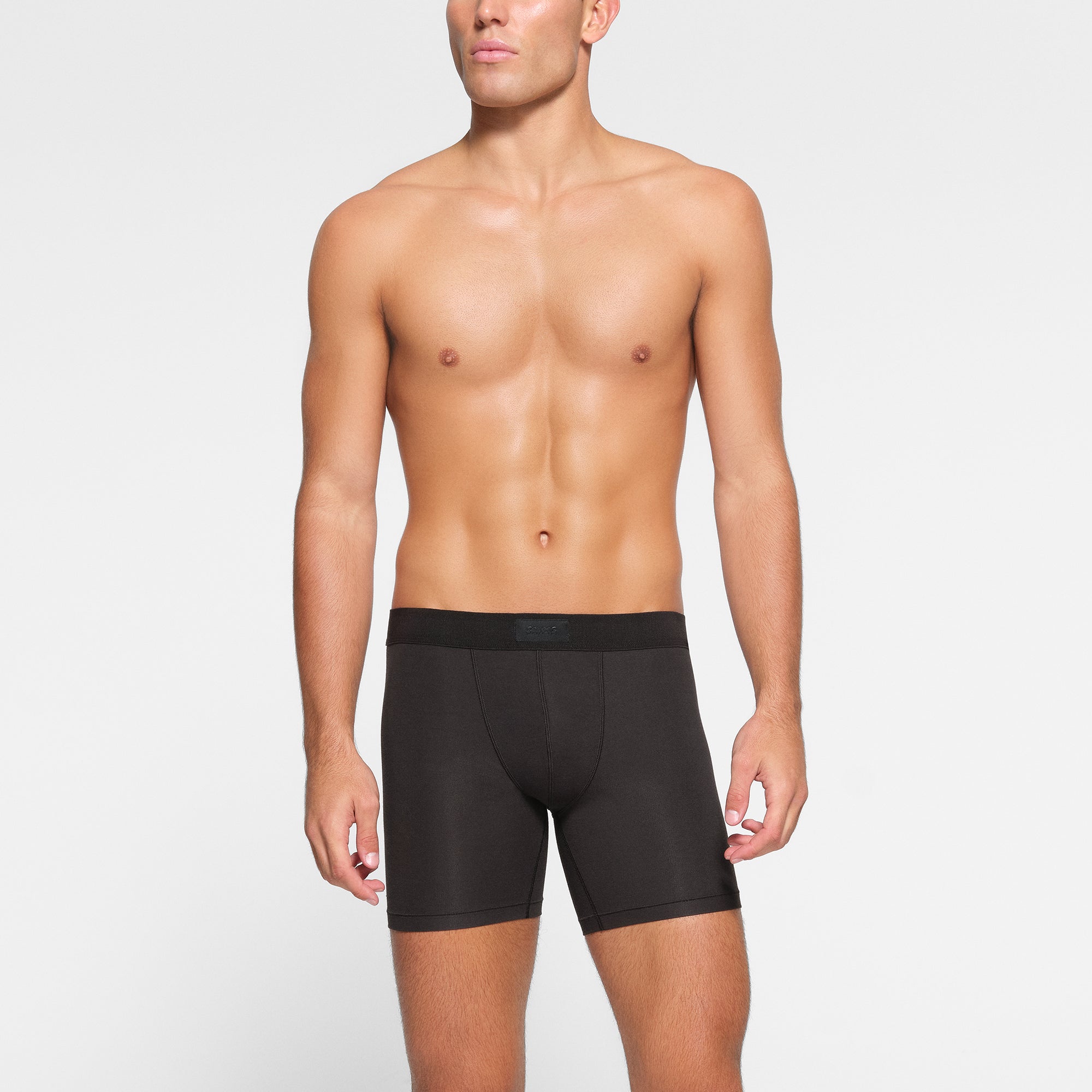 SKIMS COTTON MENS 5" BOXER BRIEF 3-PACK WORN BY A MODEL IN FRONT VIEW