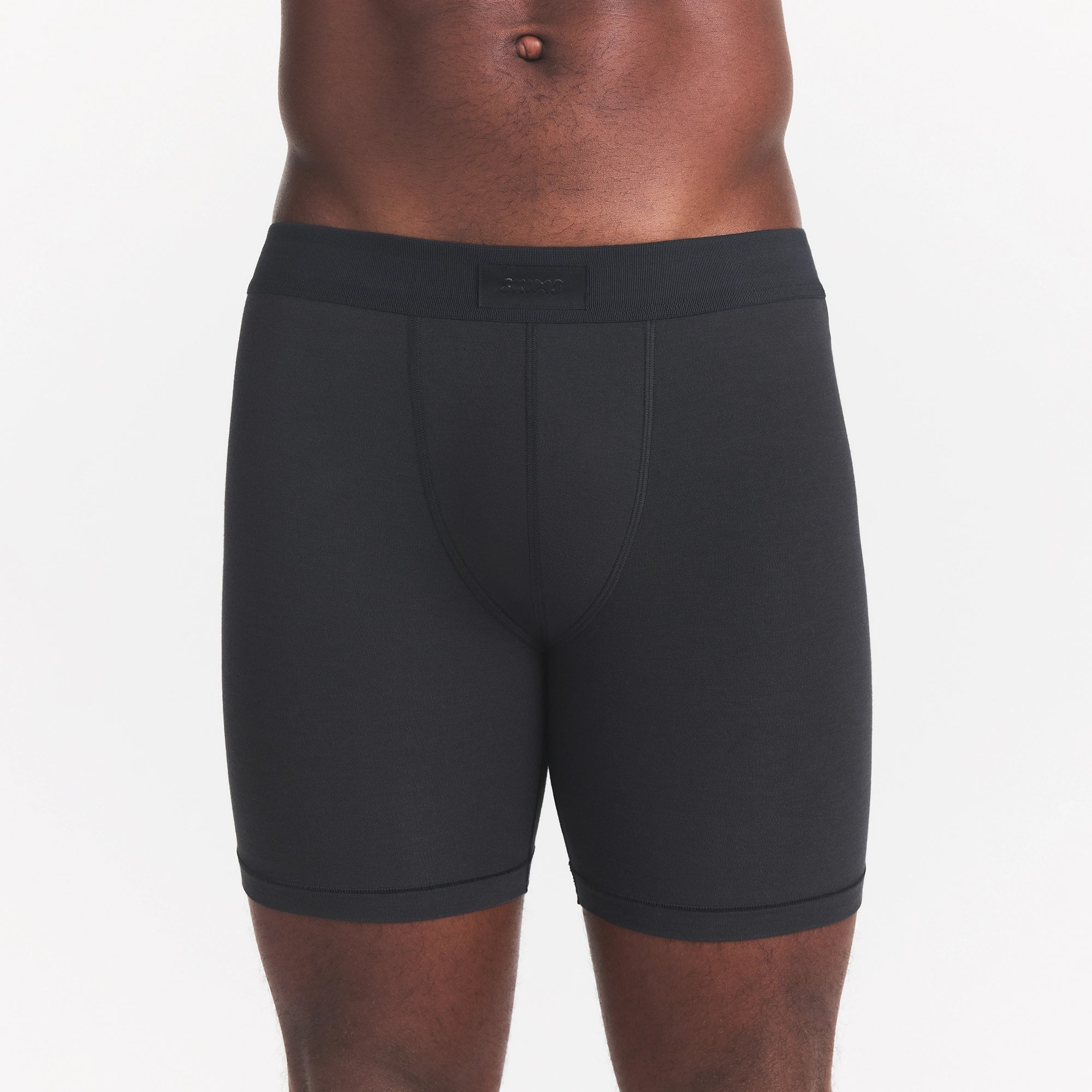 SKIMS COTTON MENS 5" BOXER BRIEF | ONYX ON A MODEL FRONT VIEW