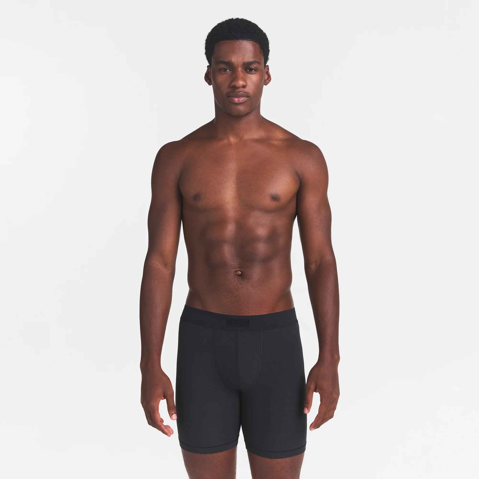 SKIMS COTTON MENS 5" BOXER BRIEF | ONYX ON A MODEL FRONT VIEW
