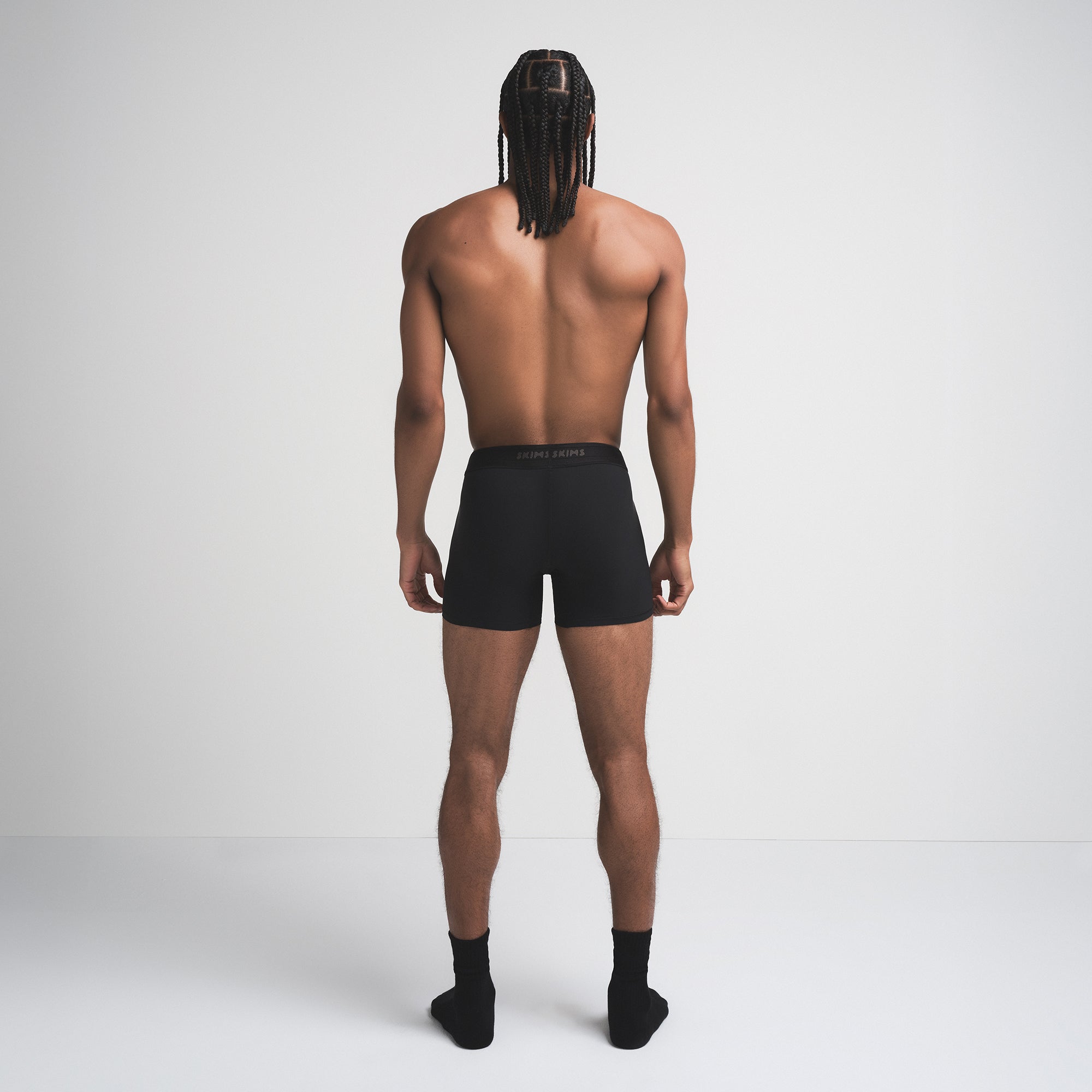 SKIMS SPORT MENS 5" BOXER BRIEF | OBSIDIAN ON A MODEL SIDE VIEW | FOCUS: 0.0, 1.0, 0.9