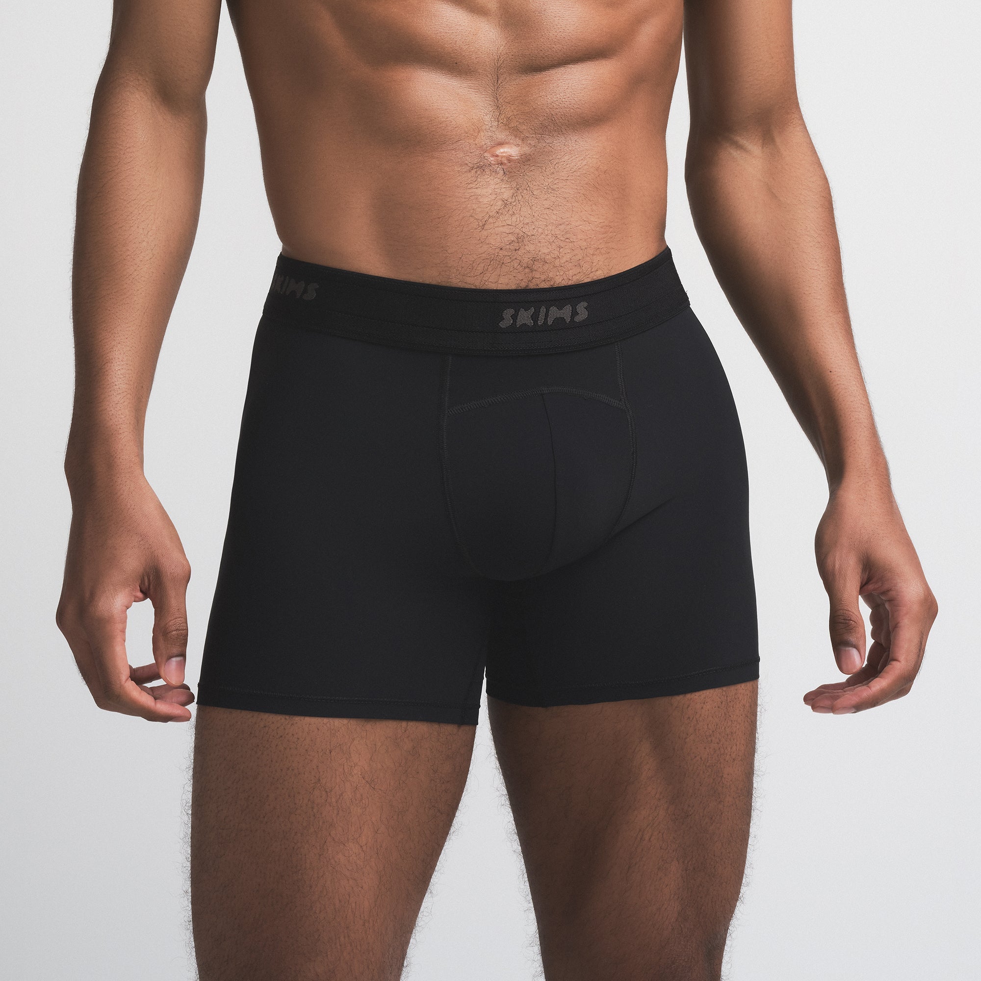 SKIMS SPORT MENS 5" BOXER BRIEF | OBSIDIAN ON A MODEL SIDE VIEW | FOCUS: 0.0, 1.0, 0.9
