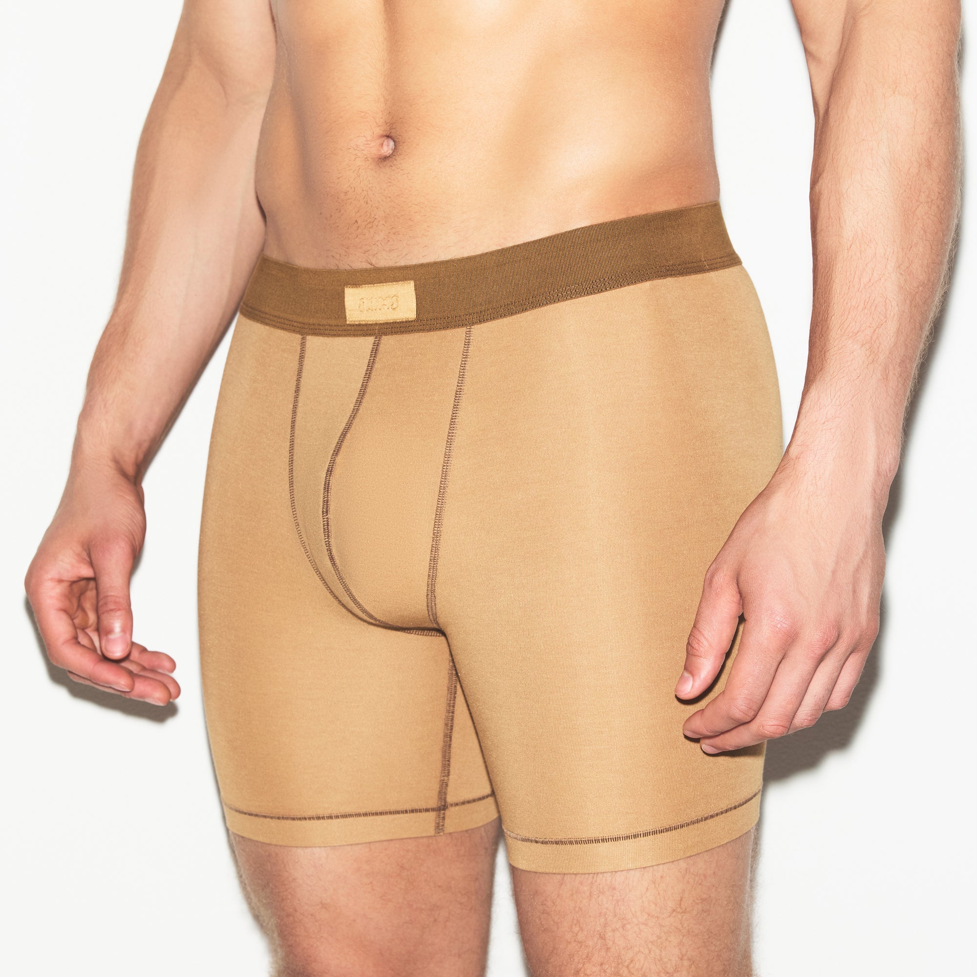 SKIMS COTTON MENS 5 INCH BOXER BRIEF 3-PACK | RUSSET MULTI ON A MODEL SIDE VIEW | FOCUS: 0.0, 1.0, 0.9