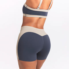 NikeSKIMS MATTE AND SHINE 5" BIKER SHORT | DEEP ROYAL/STONE ON A MODEL SIDE VIEW @ | FOCUS: 0.0, 1.0, 0.9