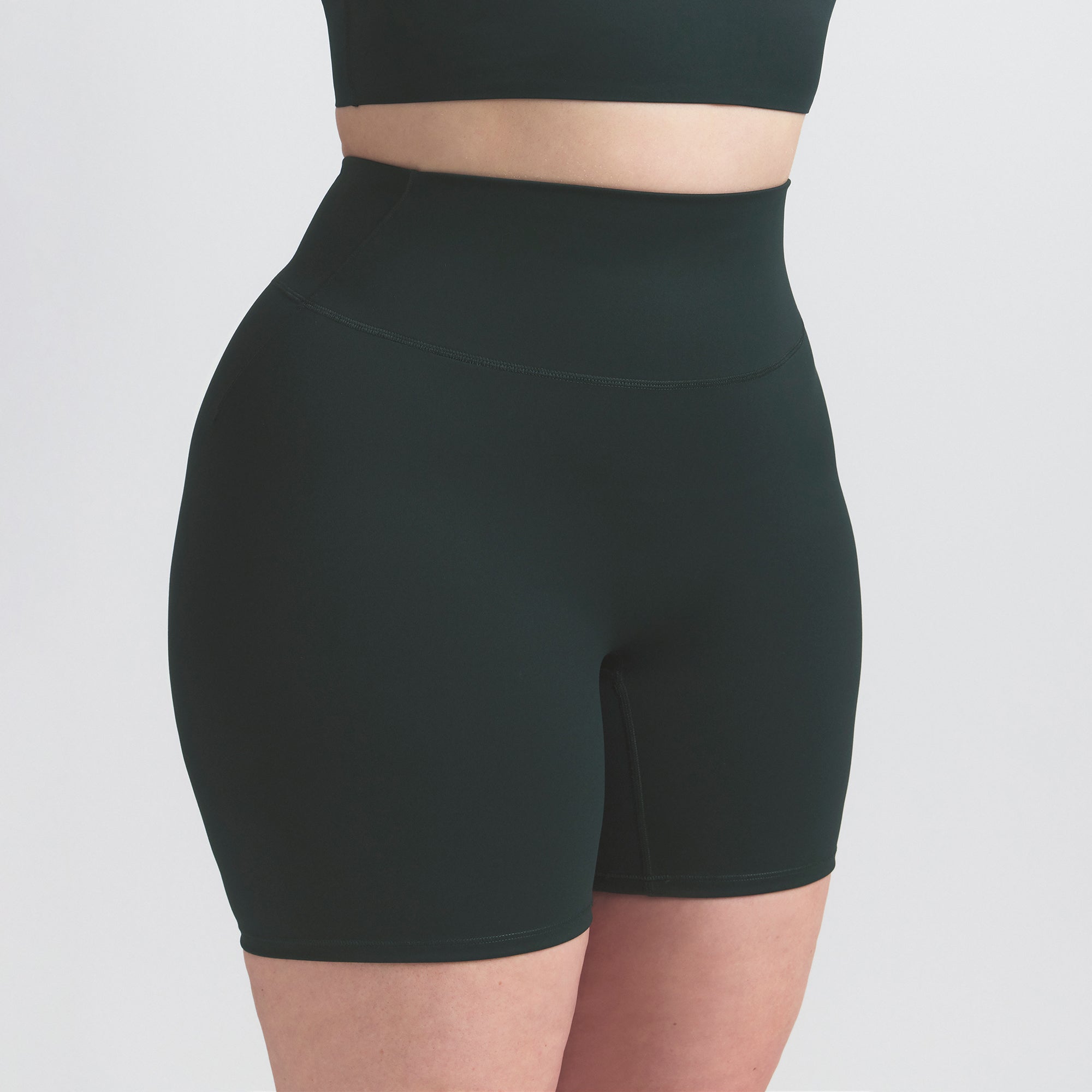 NikeSKIMS MATTE 5" BIKER SHORT | DARK TEAL ON A MODEL SIDE VIEW @ | FOCUS: 0.0, 1.0, 0.9