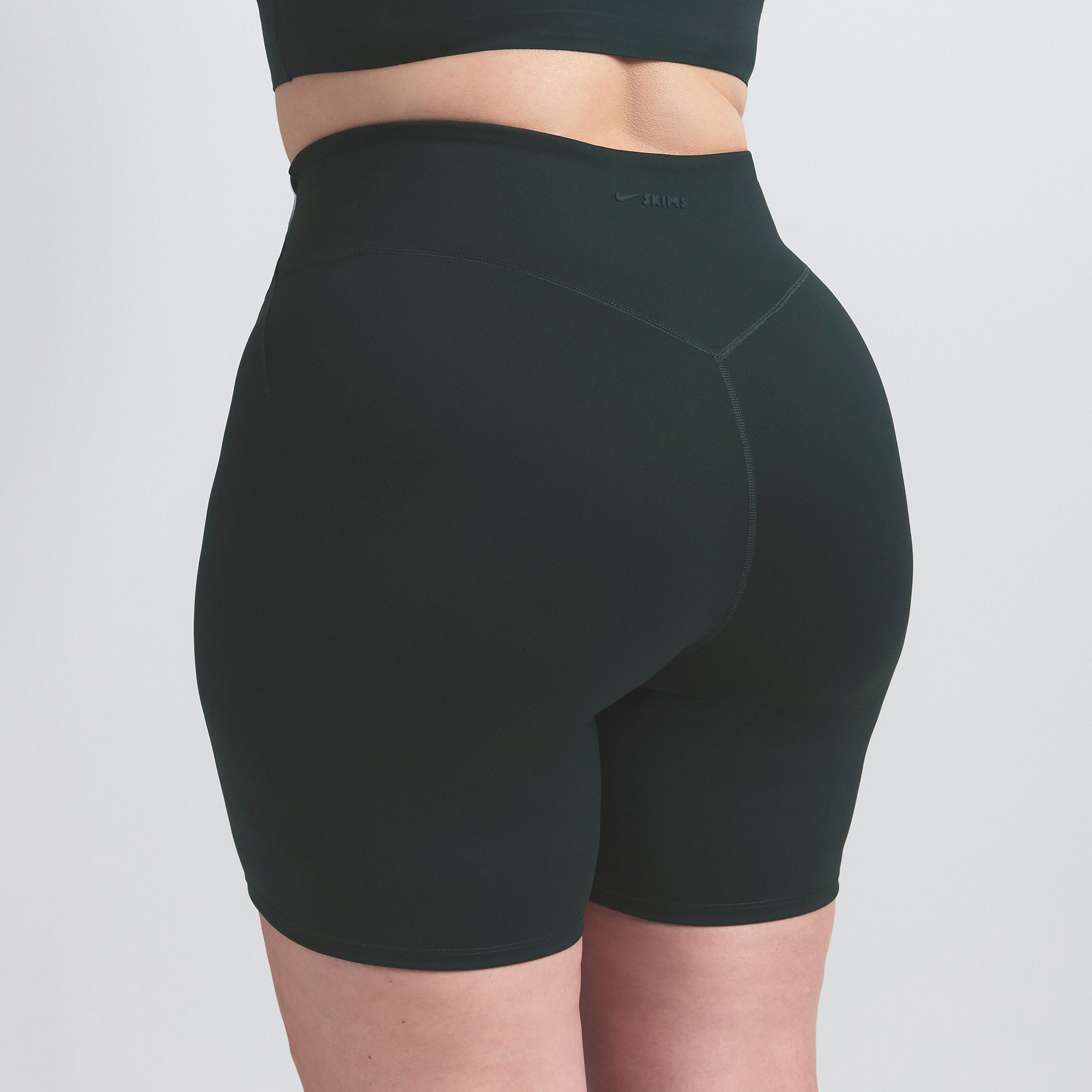 NikeSKIMS MATTE 5" BIKER SHORT | DARK TEAL ON A MODEL SIDE VIEW @ | FOCUS: 0.0, 1.0, 0.9