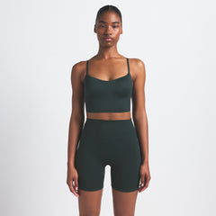 NikeSKIMS MATTE 5" BIKER SHORT | DARK TEAL ON A MODEL SIDE VIEW @ | FOCUS: 0.0, 1.0, 0.9