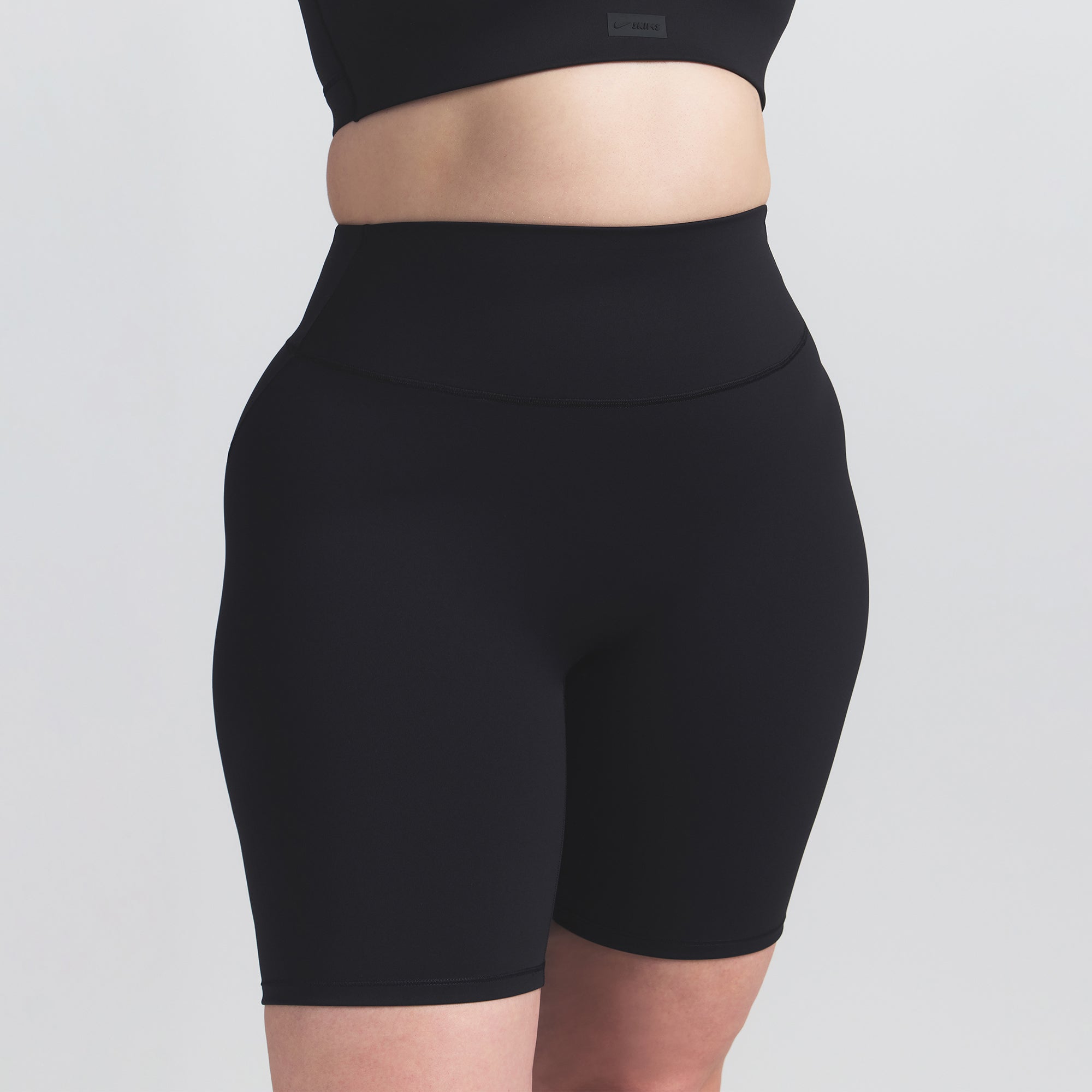 NikeSKIMS MATTE 7" BIKER SHORT | OBSIDIAN ON A MODEL FRONT VIEW