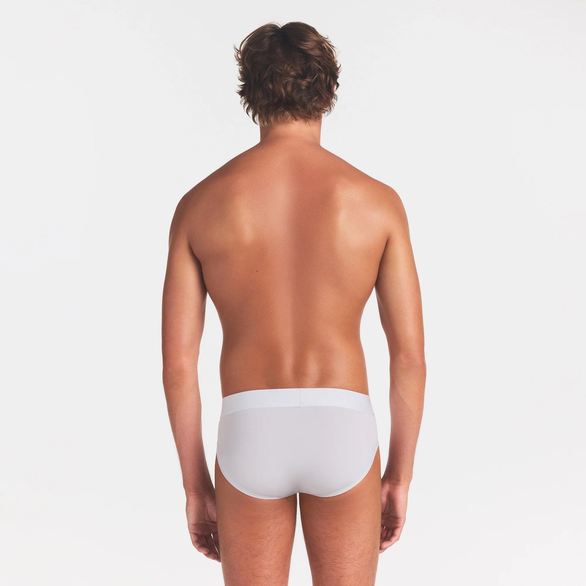 SKIMS STRETCH MENS BRIEF | CHALK ON A MODEL BACK VIEW