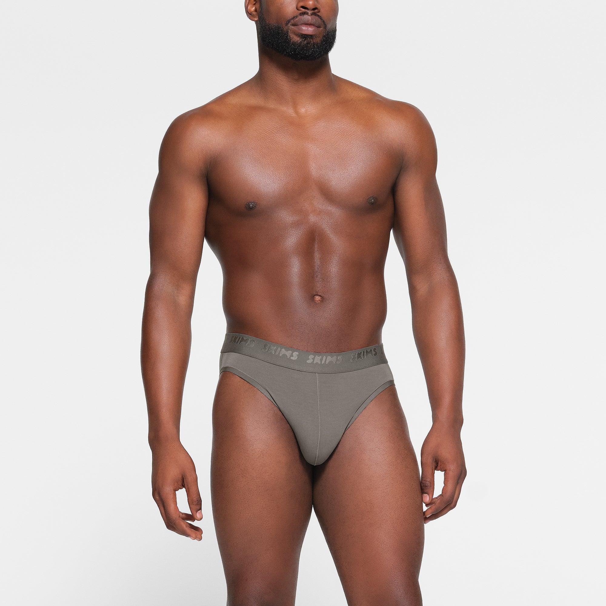 SKIMS STRETCH MENS BRIEF 3-PACK WORN BY A MODEL IN FRONT VIEW