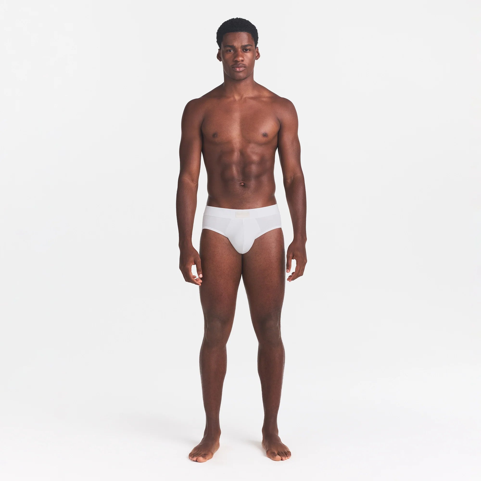 SKIMS COTTON MENS BRIEF | CHALK ON A MODEL FRONT VIEW @ | FOCUS: 0.0, 1.0, 0.9