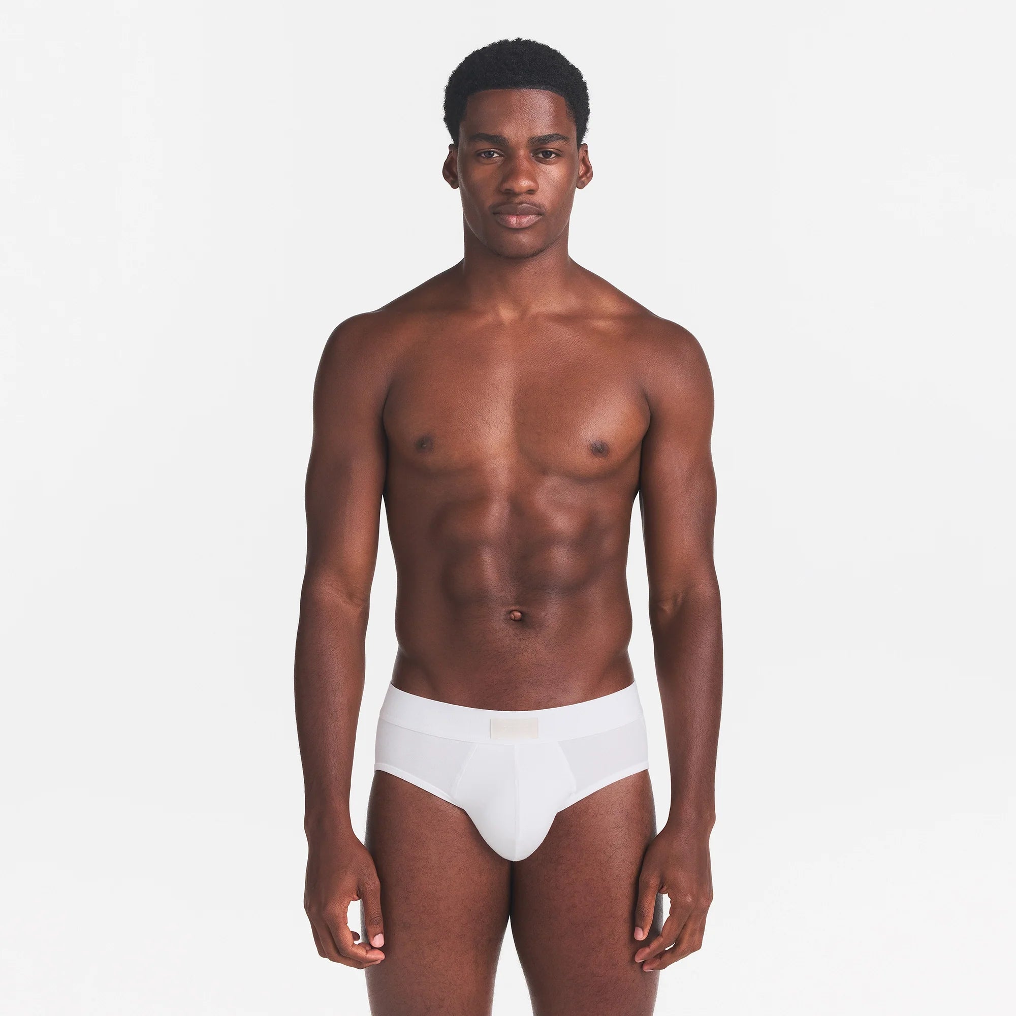 SKIMS COTTON MENS BRIEF | CHALK ON A MODEL FRONT VIEW