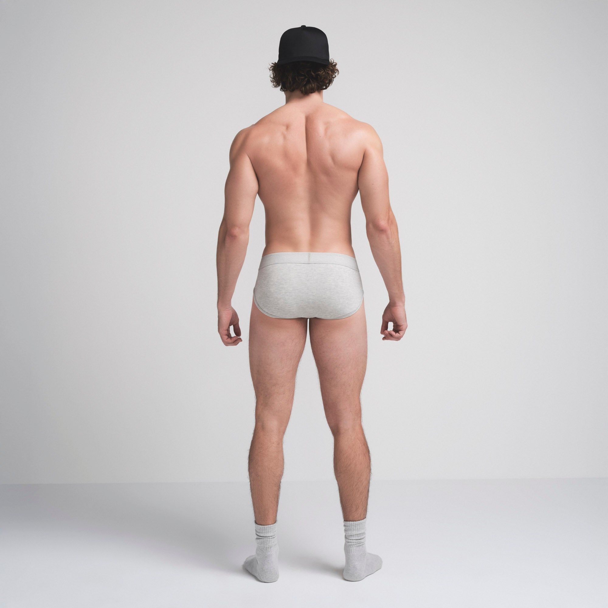 SKIMS COTTON MENS BRIEF | LIGHT HEATHER GREY ON A MODEL SIDE VIEW @ | FOCUS: 0.9, 0.1, 0.7