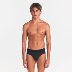 SKIMS COTTON MENS BRIEF | ONYX ON A MODEL FRONT VIEW