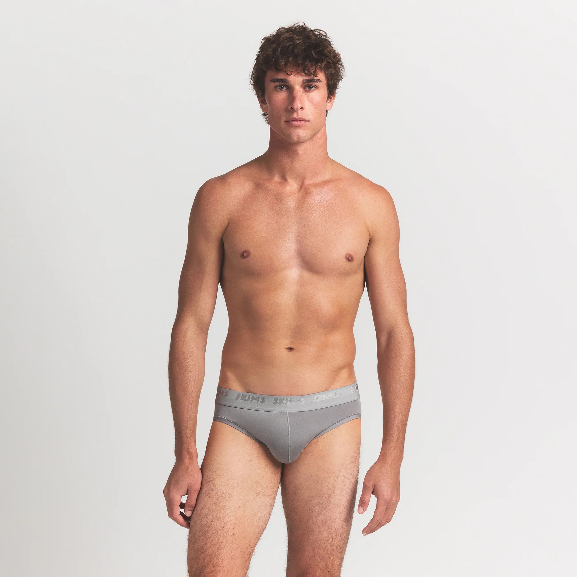 SKIMS STRETCH MENS BRIEF 3-PACK | GUNMETAL MULTI ON A MODEL FRONT VIEW