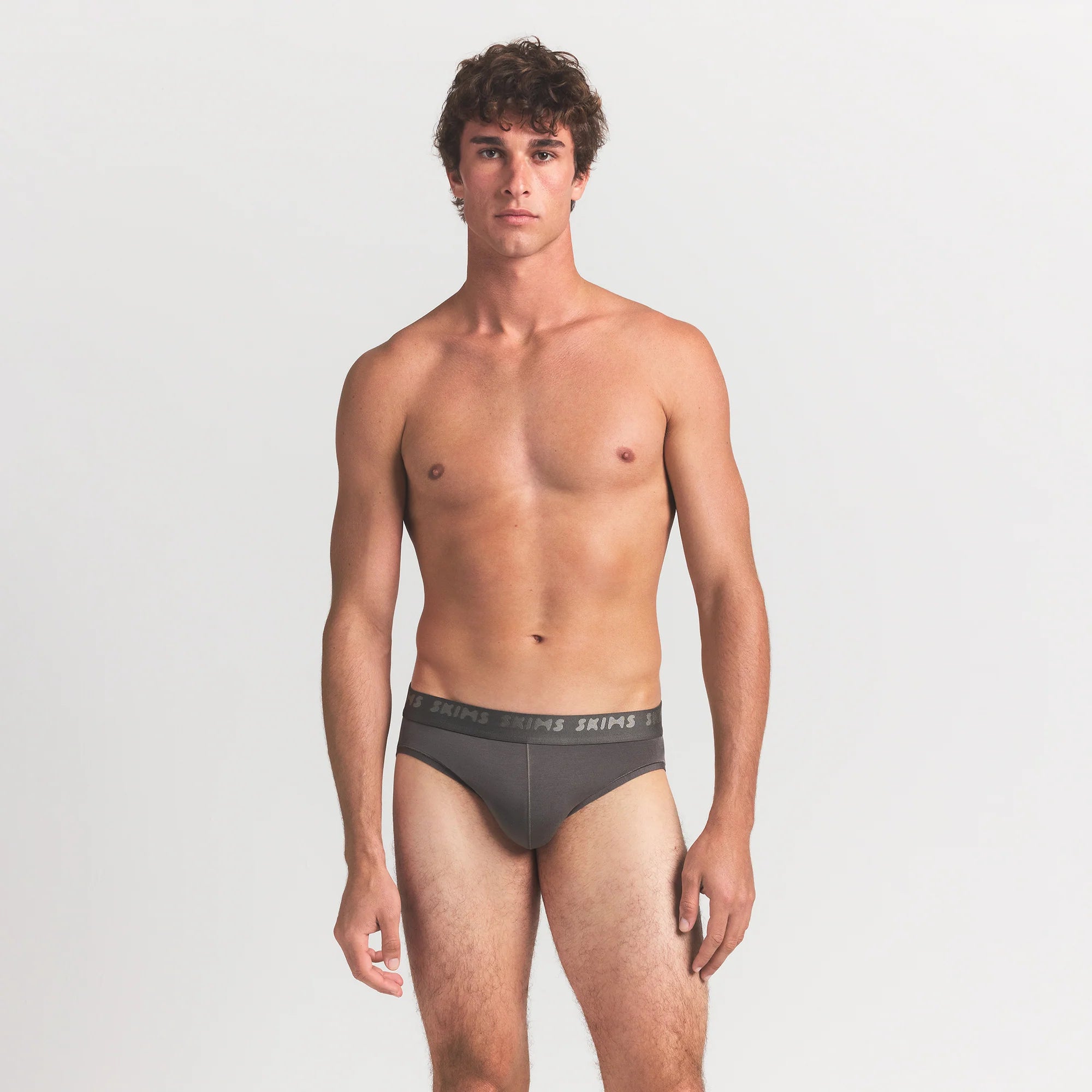 SKIMS STRETCH MENS BRIEF 3-PACK | GUNMETAL MULTI ON A MODEL FRONT VIEW