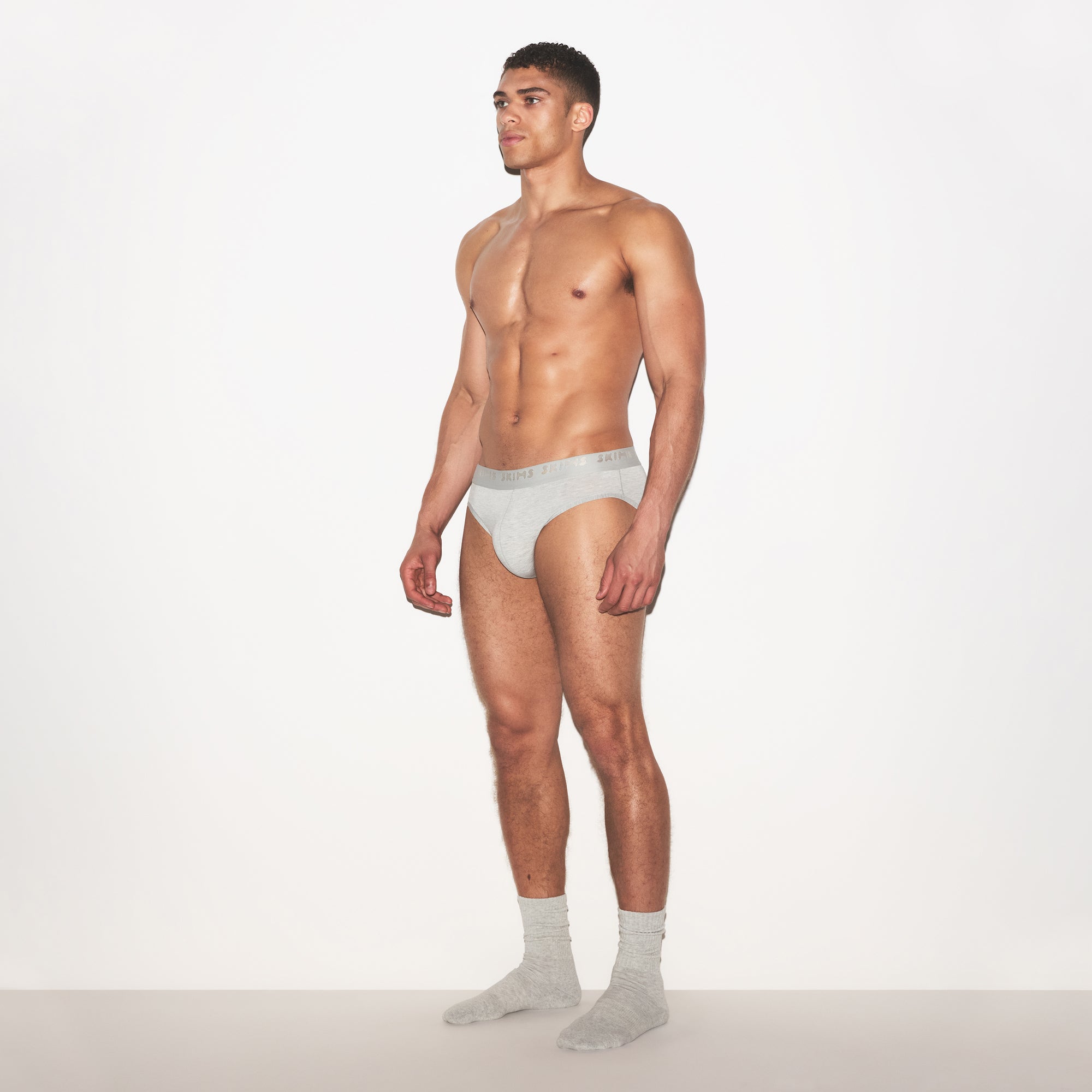 SKIMS STRETCH MENS BRIEF 3-PACK | LAUREL MULTI ON A MODEL FRONT VIEW | FOCUS: 0.0, 1.0, 0.9