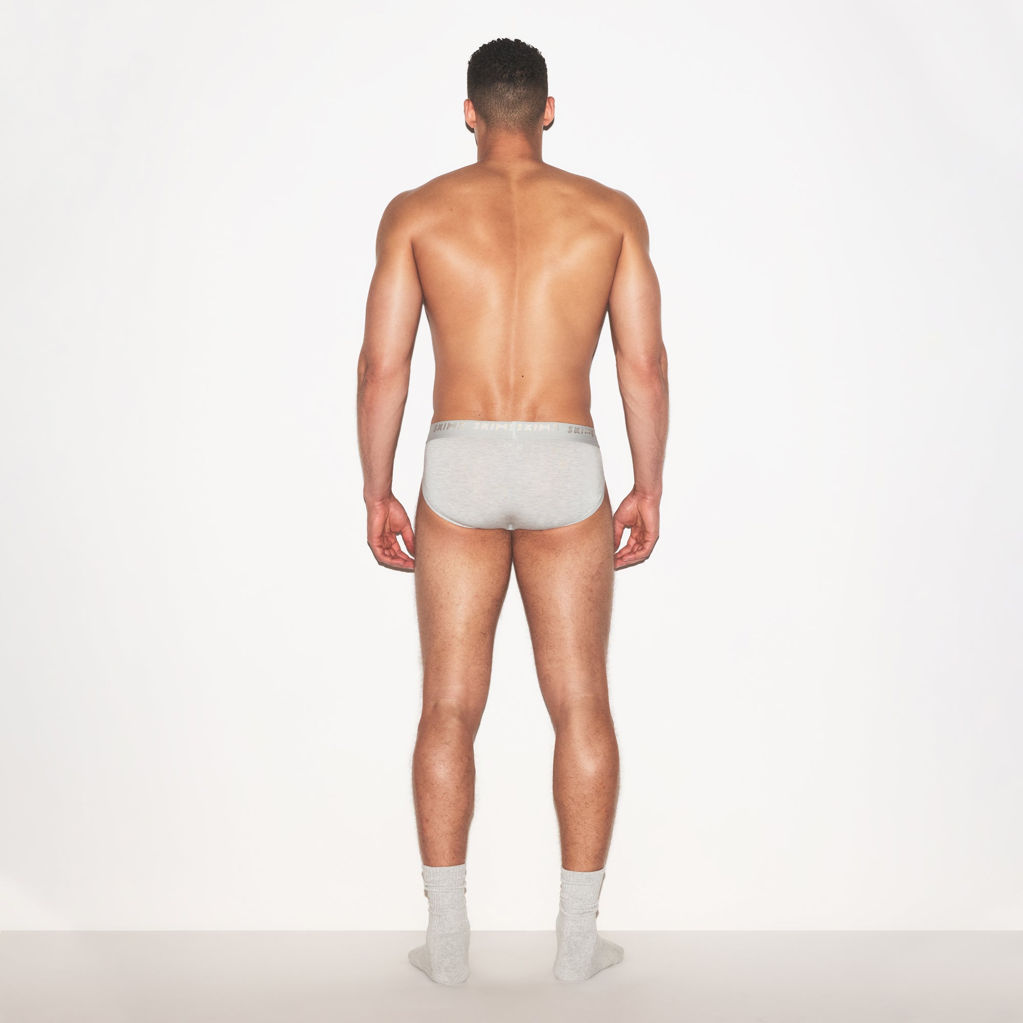SKIMS STRETCH MENS BRIEF 3-PACK | LAUREL MULTI ON A MODEL FRONT VIEW | FOCUS: 0.0, 1.0, 0.9