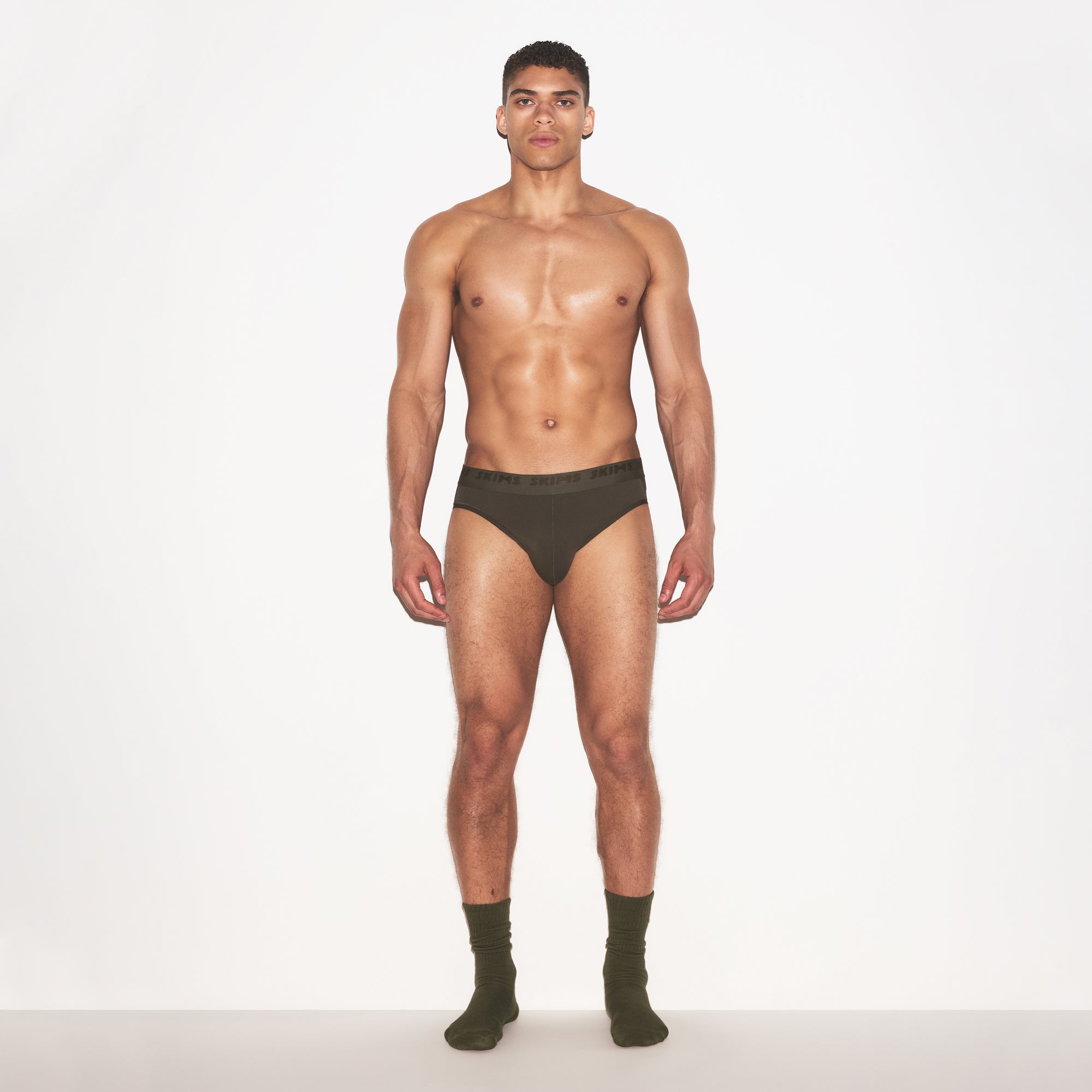 SKIMS STRETCH MENS BRIEF 3-PACK | LAUREL MULTI ON A MODEL FRONT VIEW | FOCUS: 0.0, 1.0, 0.9