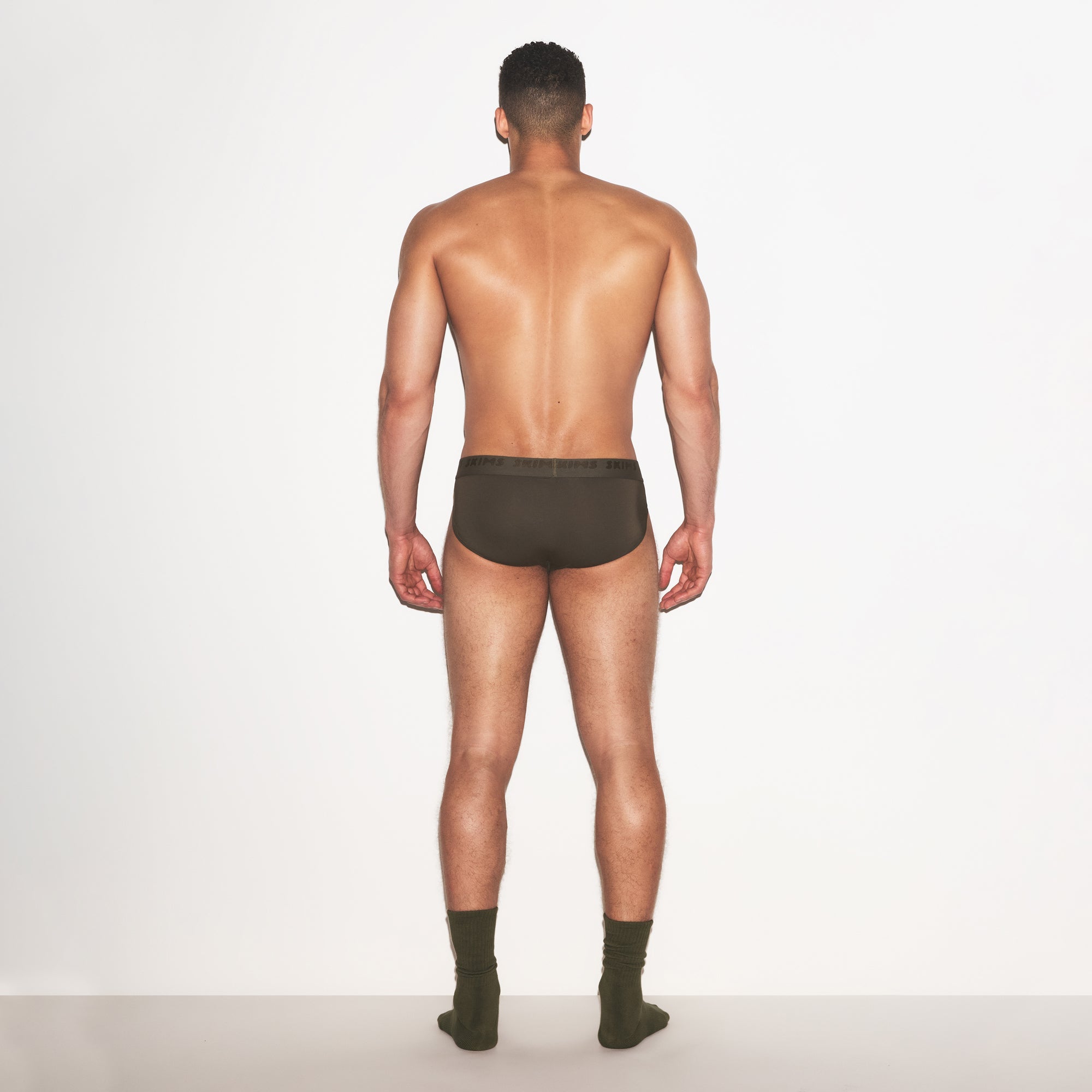 SKIMS STRETCH MENS BRIEF 3-PACK | LAUREL MULTI ON A MODEL FRONT VIEW | FOCUS: 0.0, 1.0, 0.9