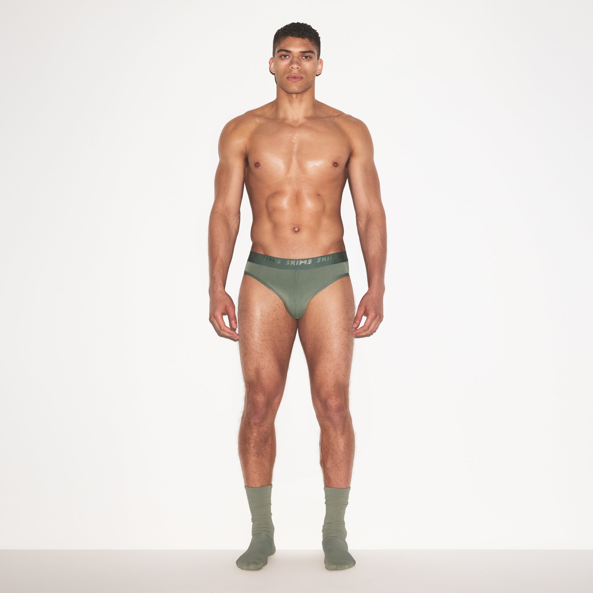 SKIMS STRETCH MENS BRIEF 3-PACK | LAUREL MULTI ON A MODEL FRONT VIEW | FOCUS: 0.0, 1.0, 0.9