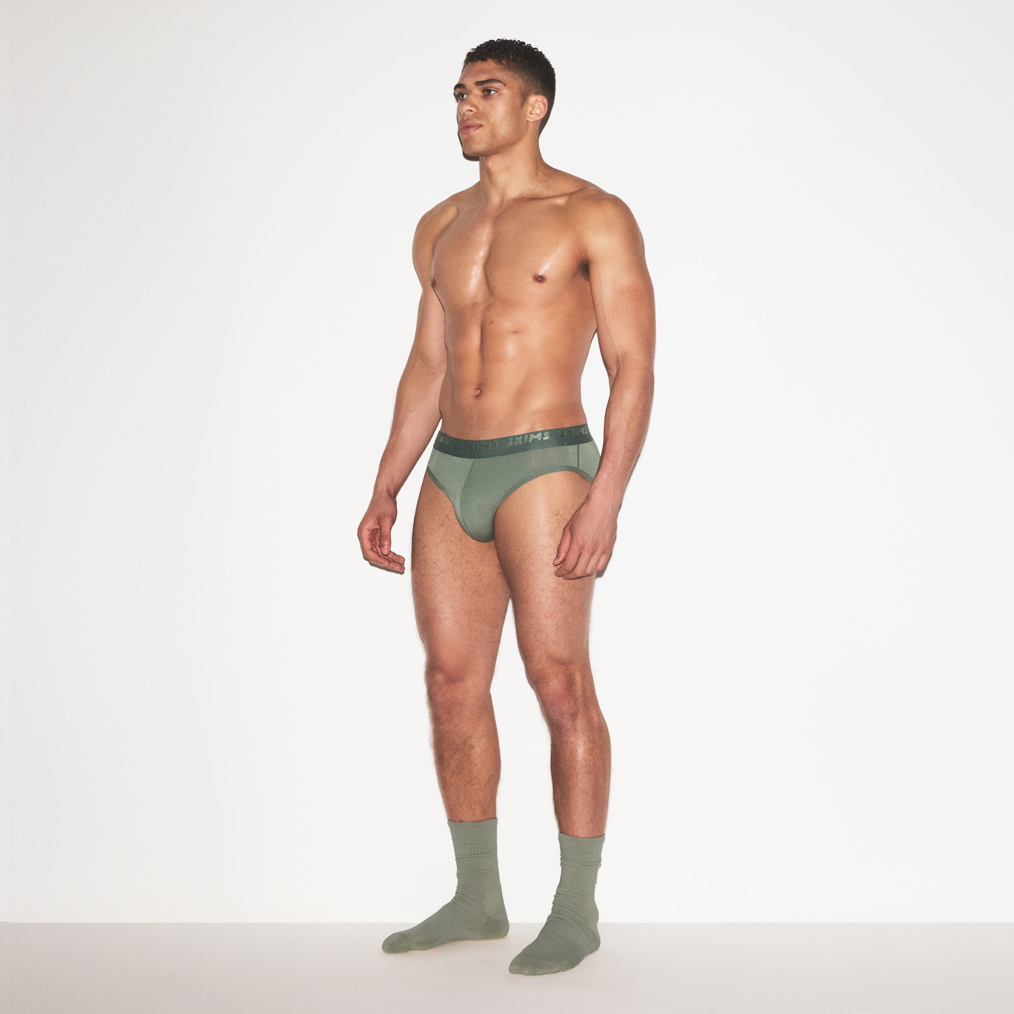 SKIMS STRETCH MENS BRIEF 3-PACK | LAUREL MULTI ON A MODEL FRONT VIEW | FOCUS: 0.0, 1.0, 0.9