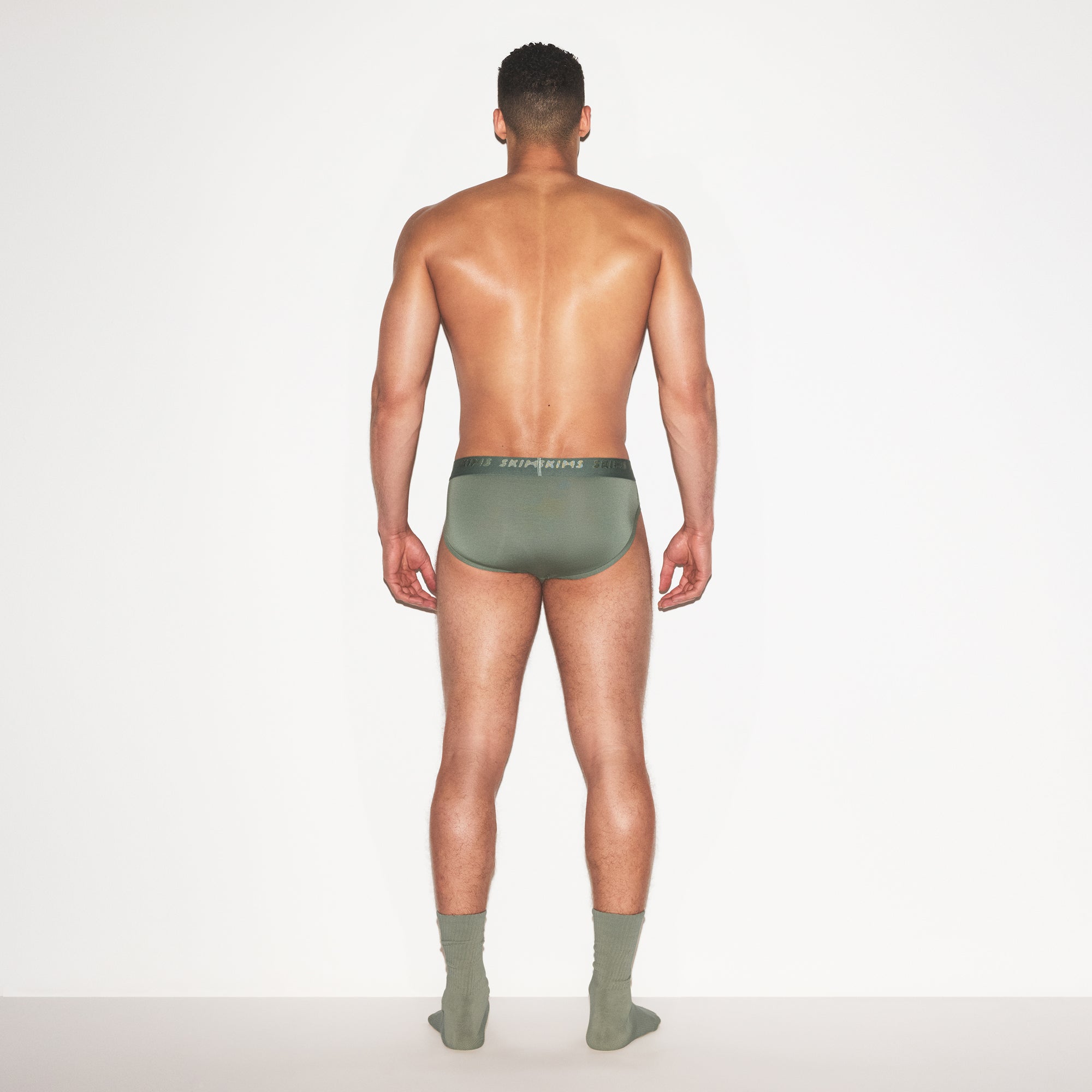 SKIMS STRETCH MENS BRIEF 3-PACK | LAUREL MULTI ON A MODEL FRONT VIEW | FOCUS: 0.0, 1.0, 0.9
