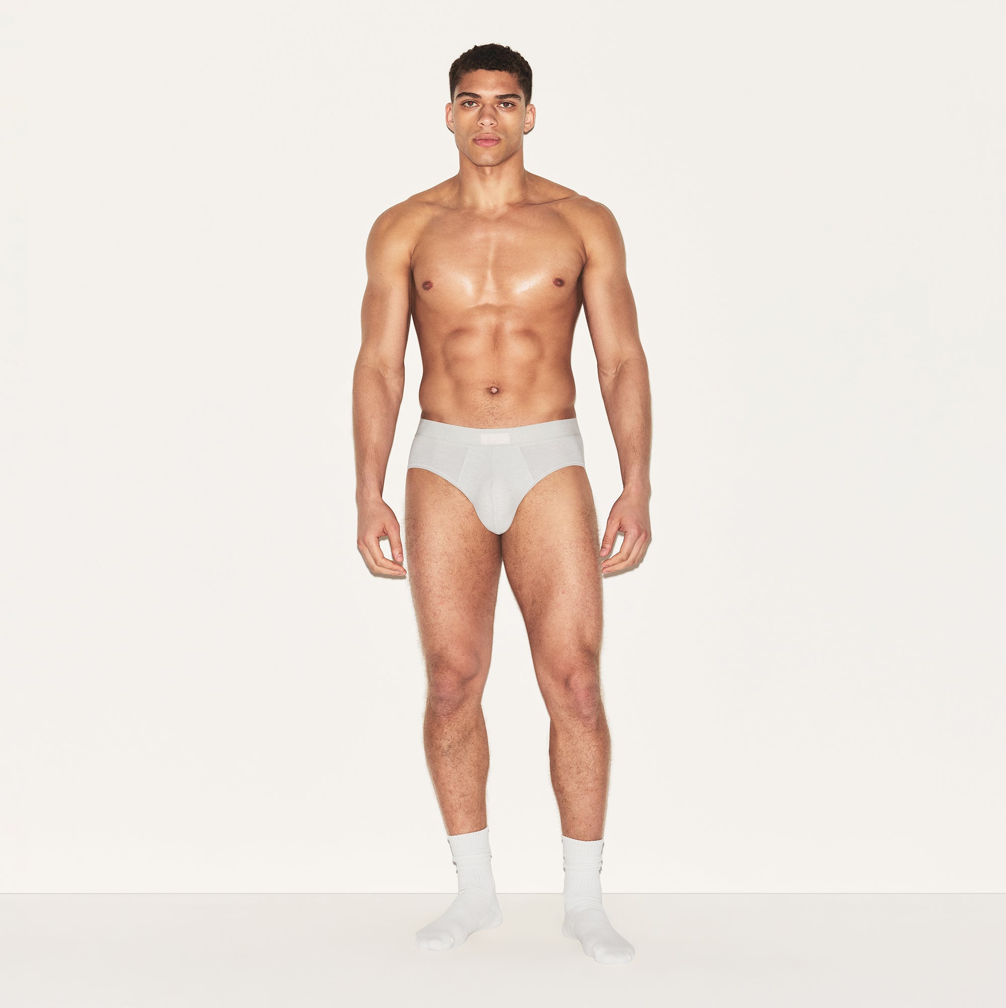 SKIMS COTTON MENS BRIEF 3-PACK | HEATHER MULTI ON A MODEL FRONT VIEW | FOCUS: 0.0, 1.0, 0.9