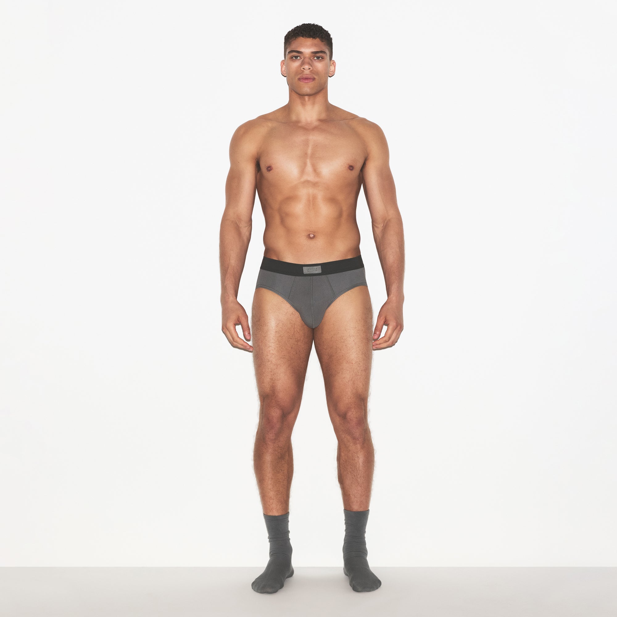 SKIMS COTTON MENS BRIEF 3-PACK | HEATHER MULTI ON A MODEL FRONT VIEW | FOCUS: 0.0, 1.0, 0.9