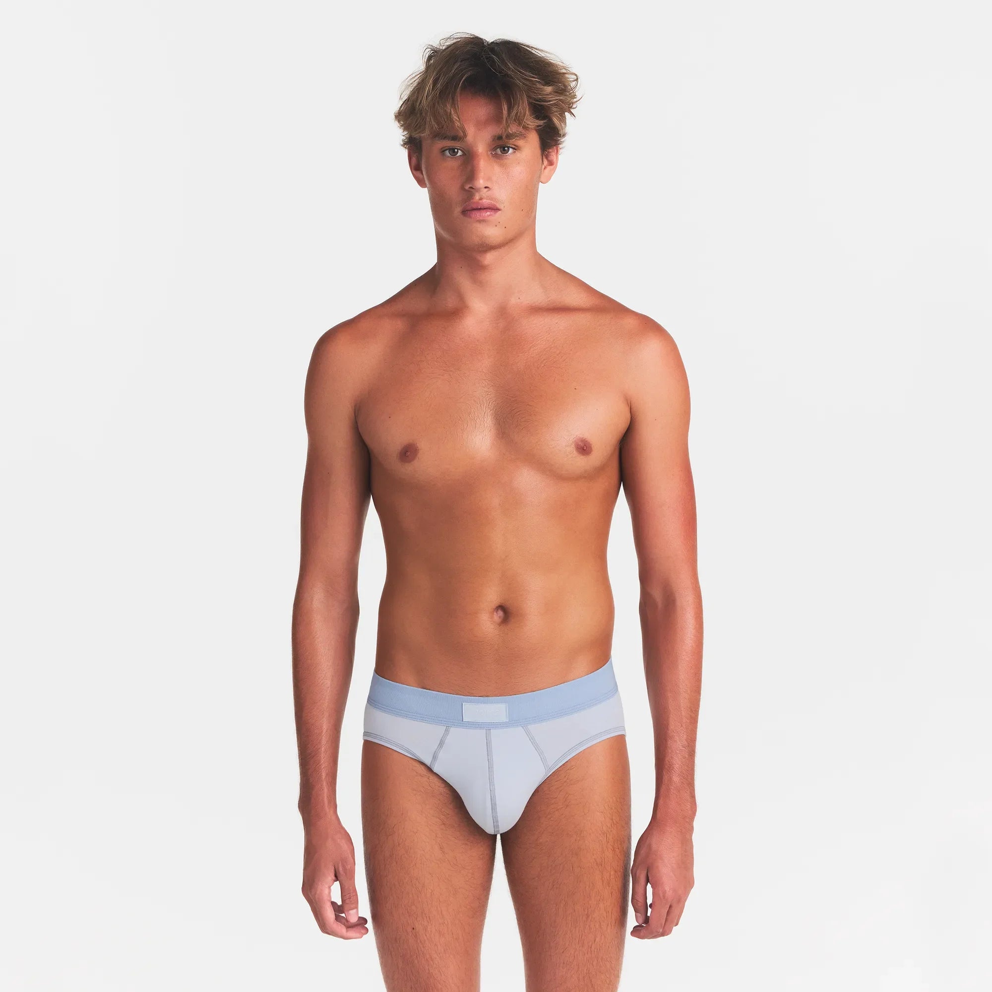 SKIMS COTTON MENS BRIEF 3-PACK | NIMBUS MULTI ON A MODEL FRONT VIEW @ | FOCUS: 0.0, 1.0, 0.9