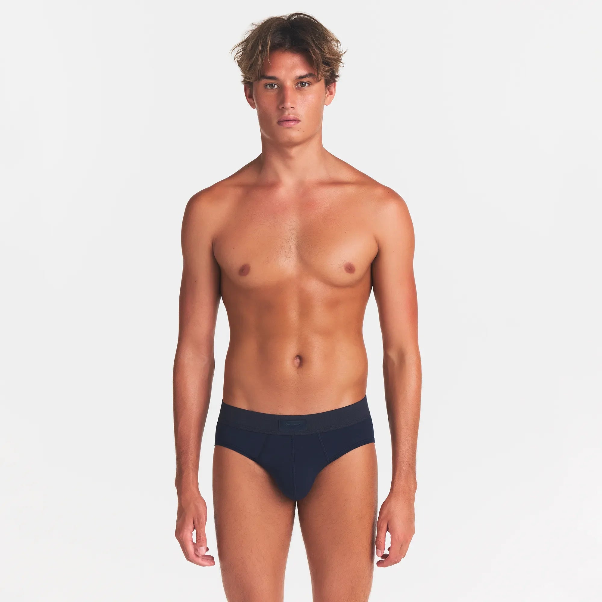 SKIMS COTTON MENS BRIEF 3-PACK | NIMBUS MULTI ON A MODEL FRONT VIEW @ | FOCUS: 0.0, 1.0, 0.9