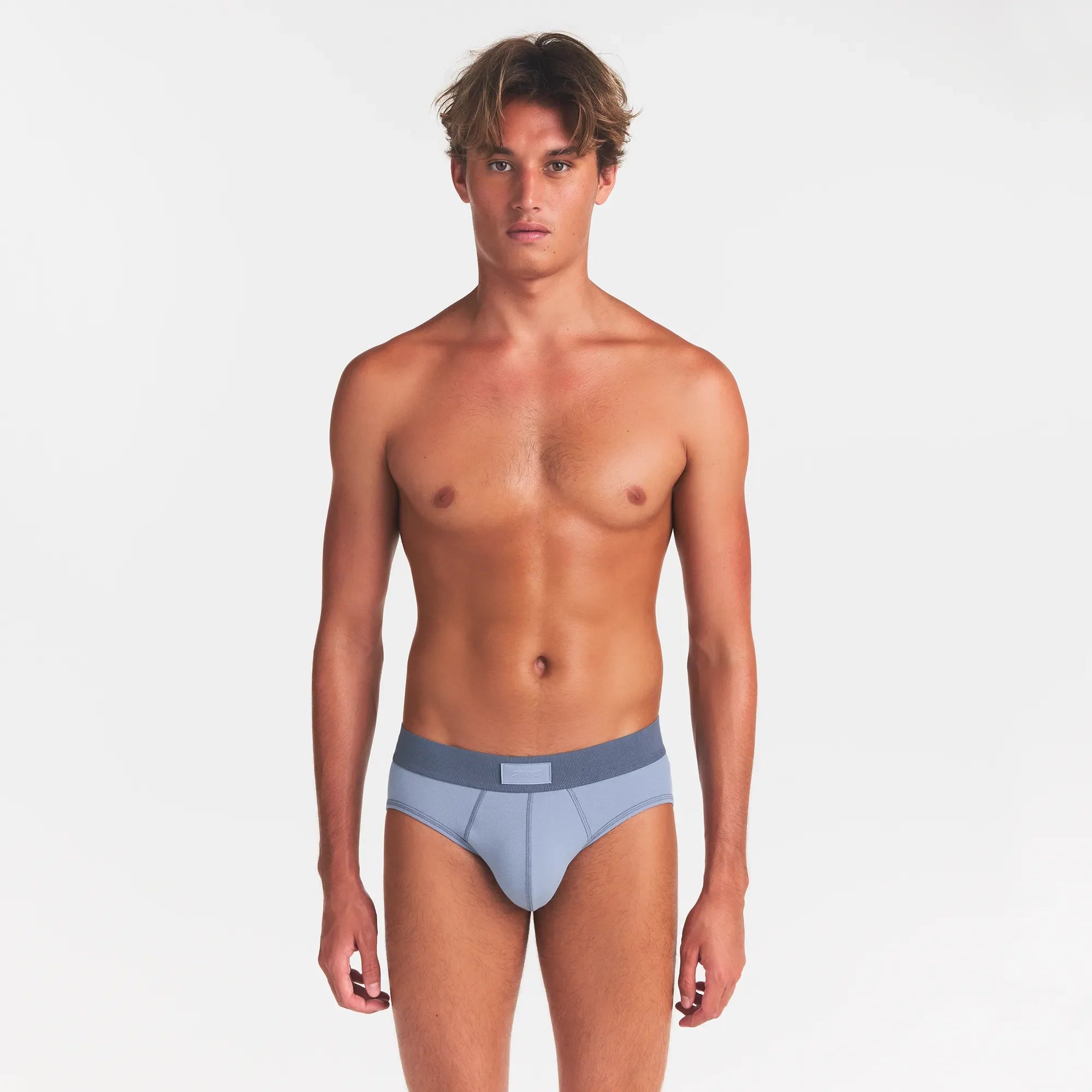 SKIMS COTTON MENS BRIEF 3-PACK | NIMBUS MULTI ON A MODEL FRONT VIEW @ | FOCUS: 0.0, 1.0, 0.9
